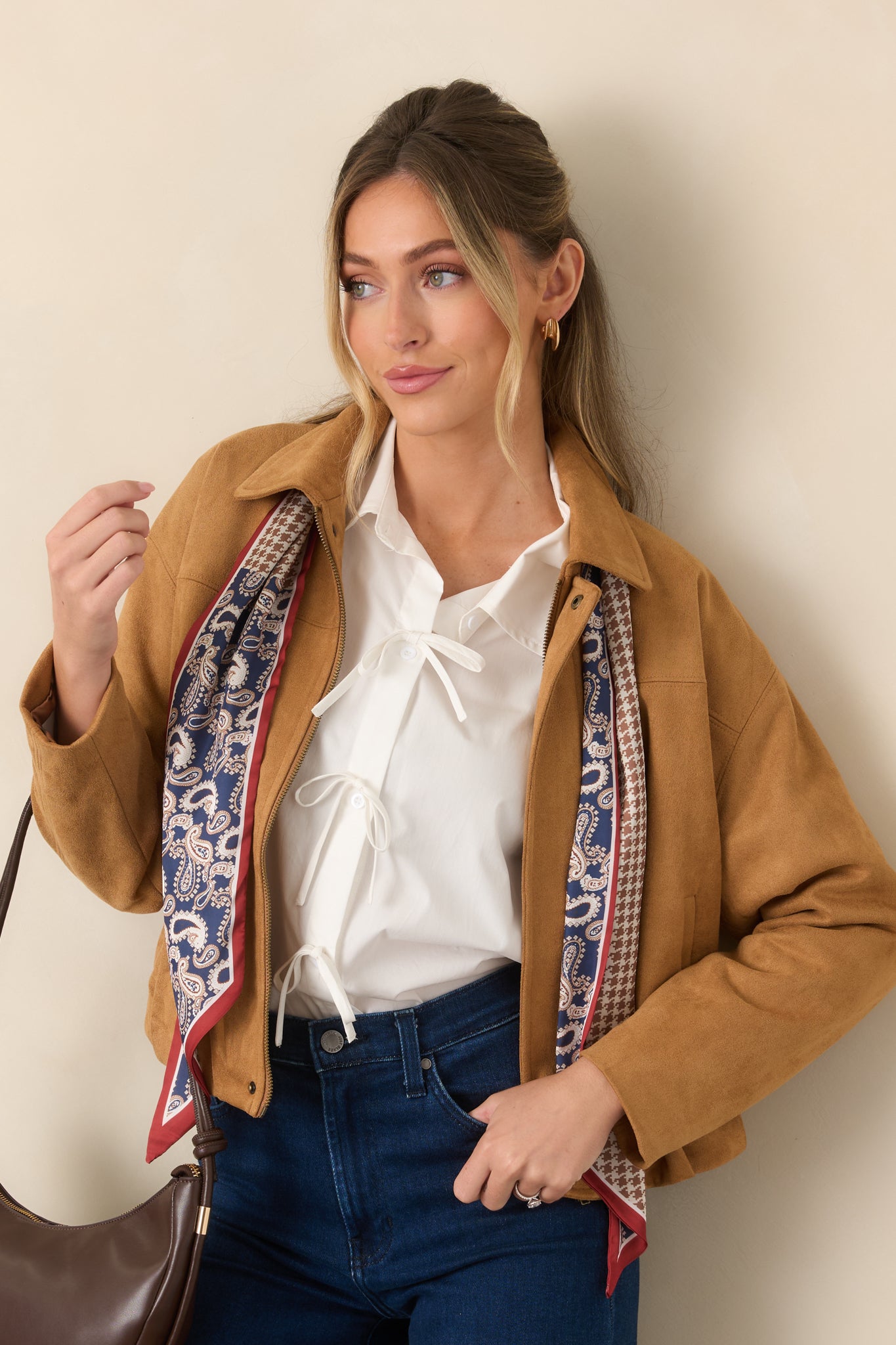 Close view of the faux suede jacket highlighting the pointed collar, clean front placket, and smooth stretch fabric.