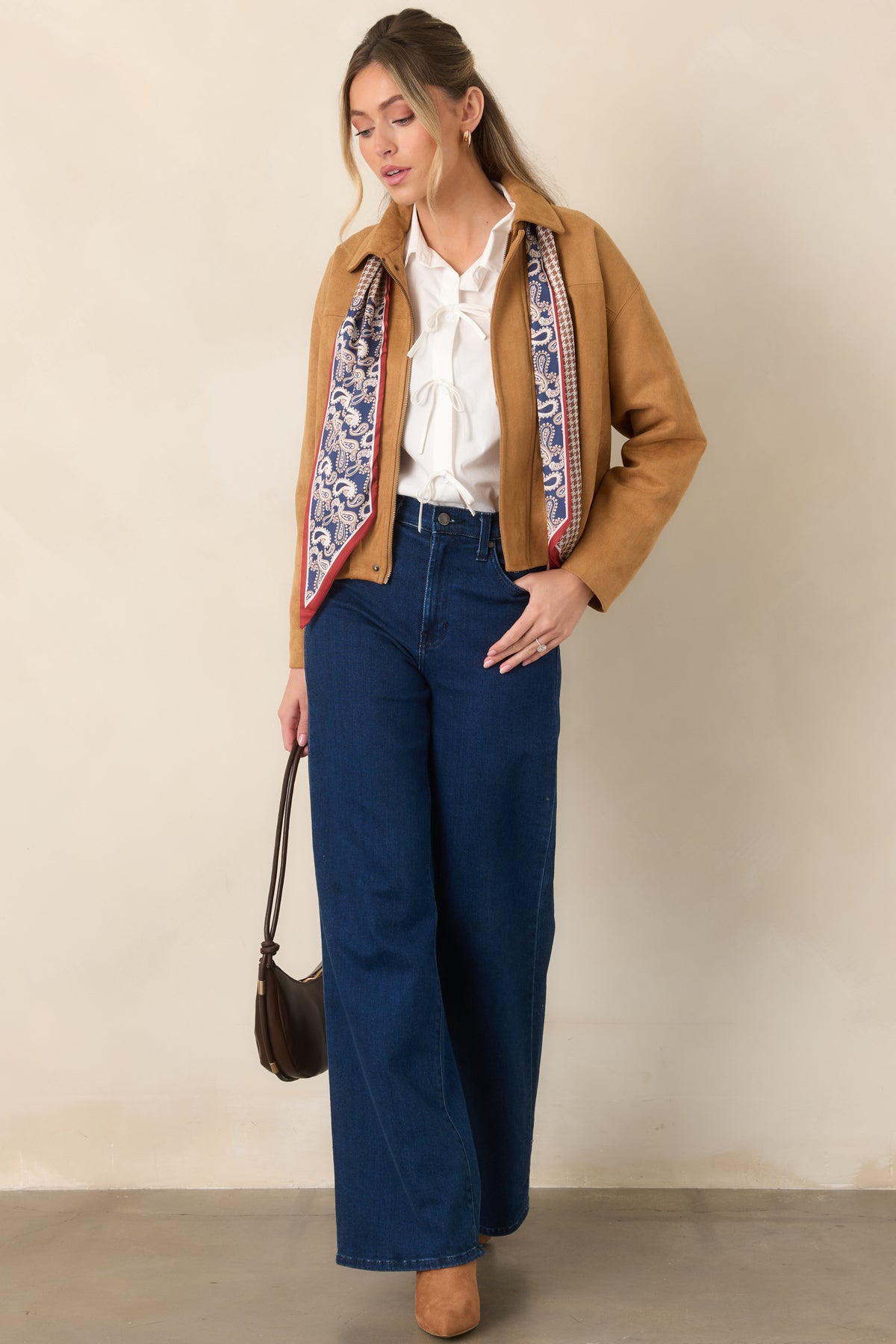 Stretch faux suede jacket showcasing a smooth finish, concealed front zipper, defined seams, relaxed sleeves, and an easy gathered waist.