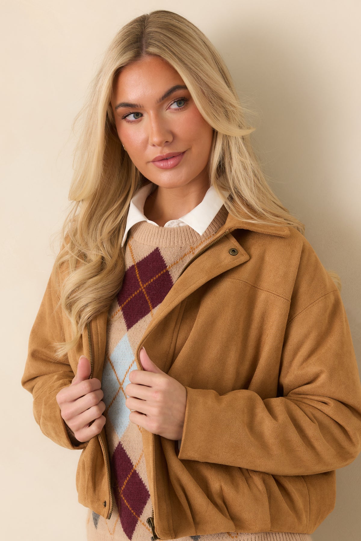 Pointed collar and concealed zip-front placket give this soft faux suede jacket a clean, streamlined appearance.