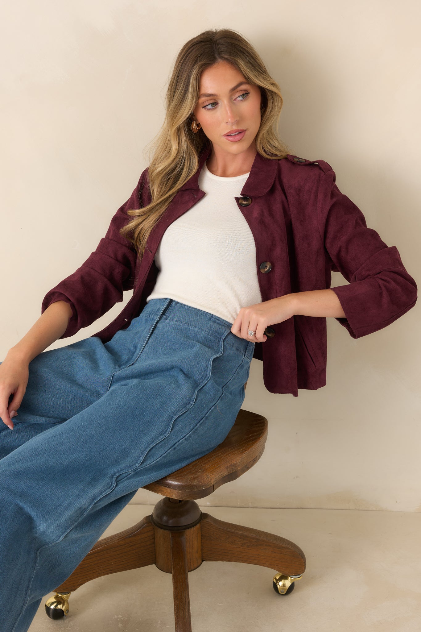 Close view of the faux suede jacket highlighting the rounded collar, button-front closure, and tailored shoulder tabs.