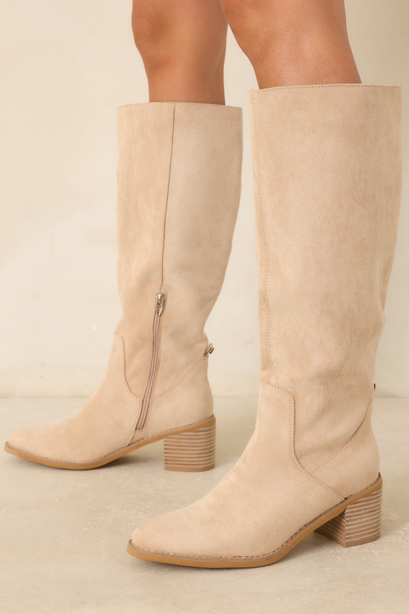 Faux suede knee-high boots in a versatile beige hue with an inner side zipper closure and streamlined silhouette.
