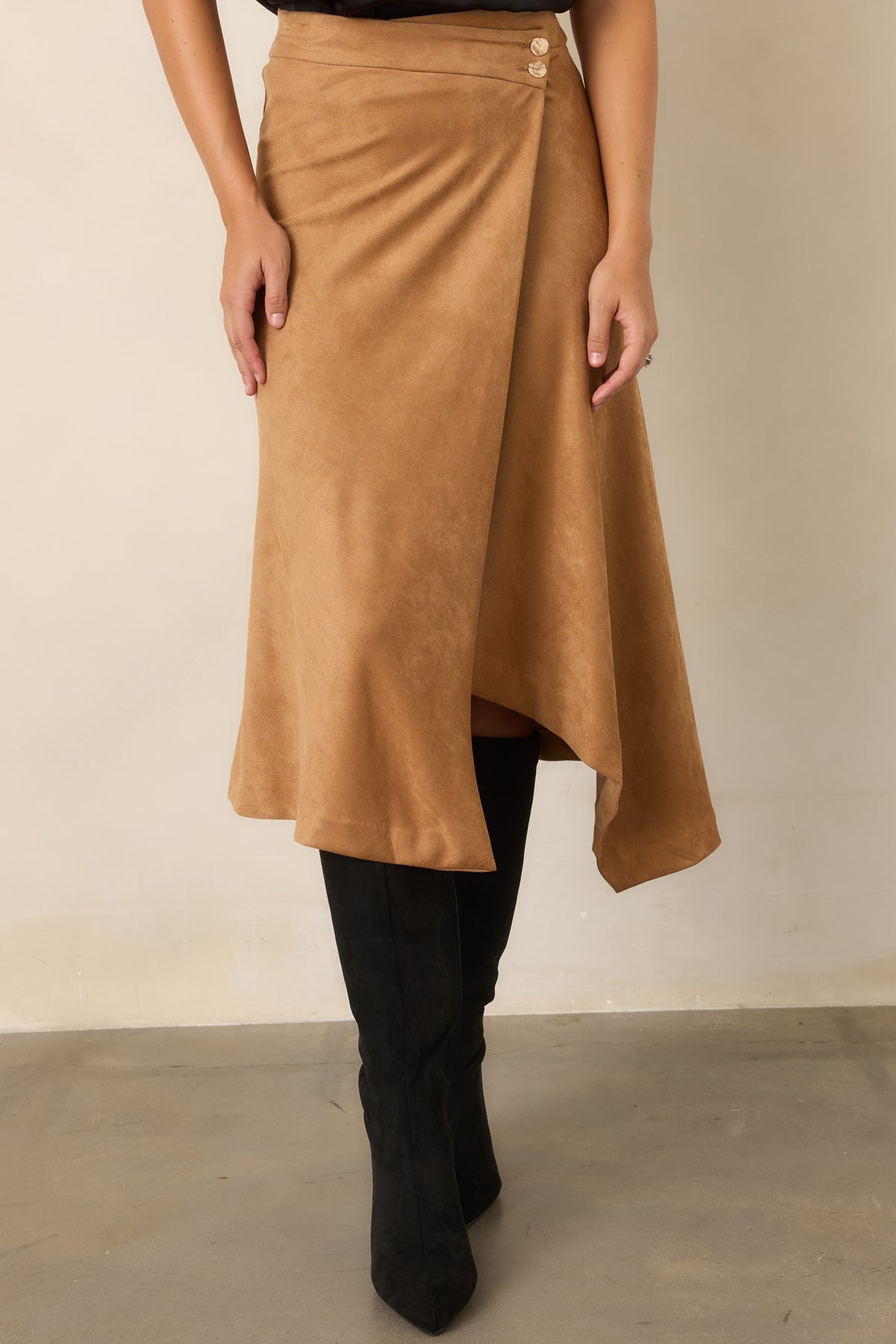 Faux suede skirt showcasing the clean high-rise waist and overlapping wrap-front design.