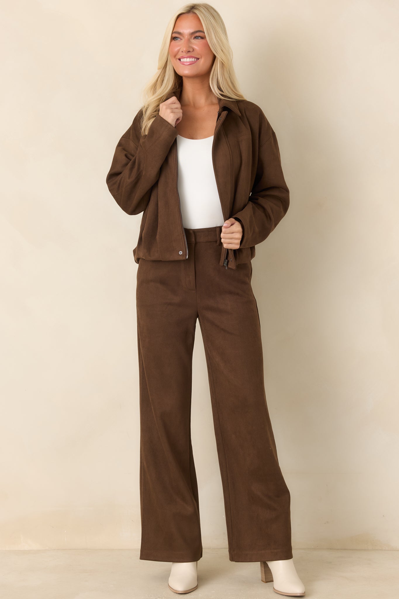 Faux suede zip-front jacket showcasing its streamlined placket, defined seams, relaxed proportions, and softly gathered hem.