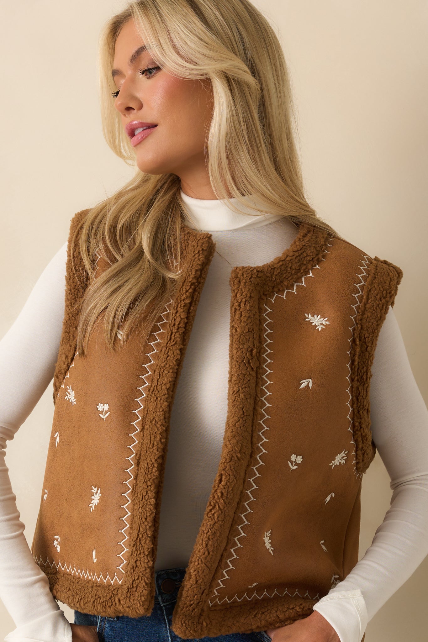 Midsection crop showing the faux suede texture, open front, and faux shearling lining.