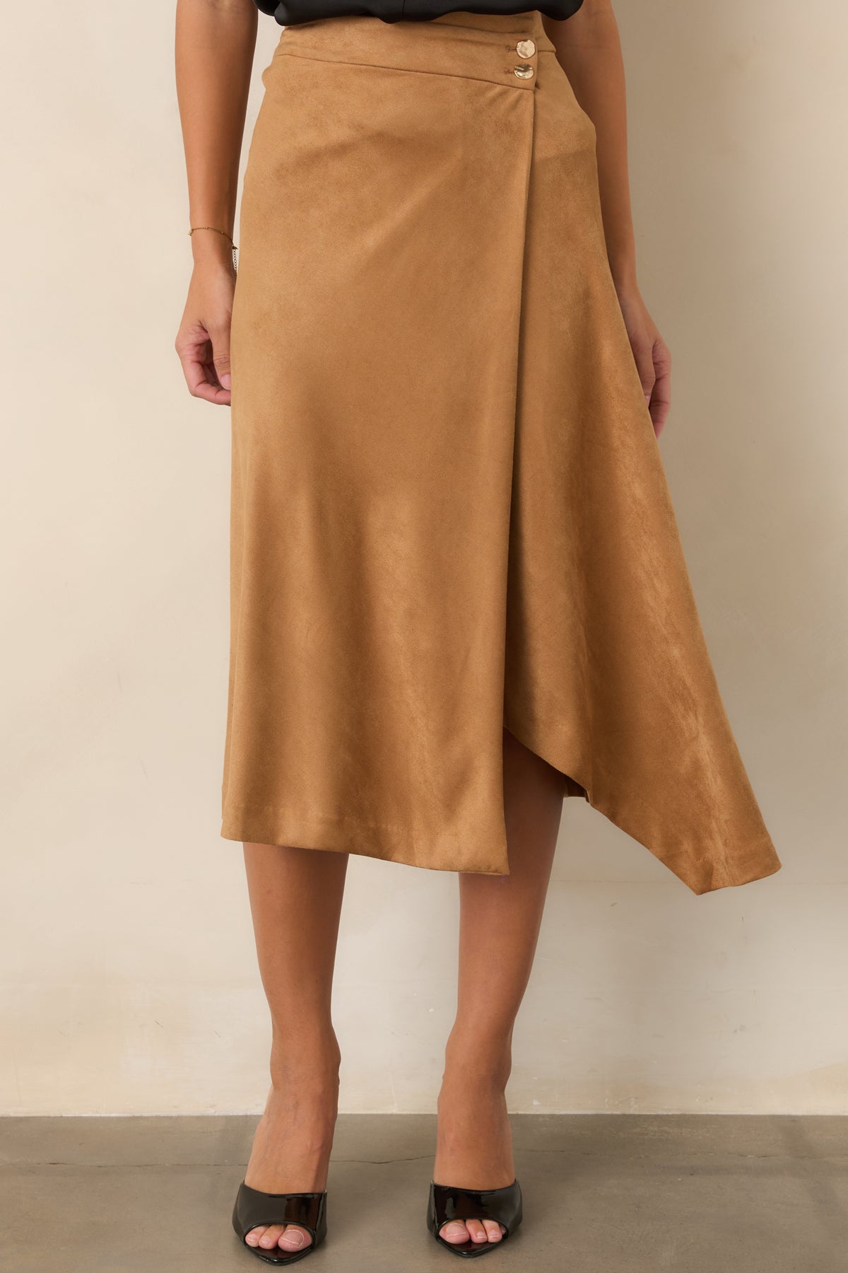 Angled hem creates graceful drape across the stretch faux suede skirt, complementing its clean wrap silhouette.