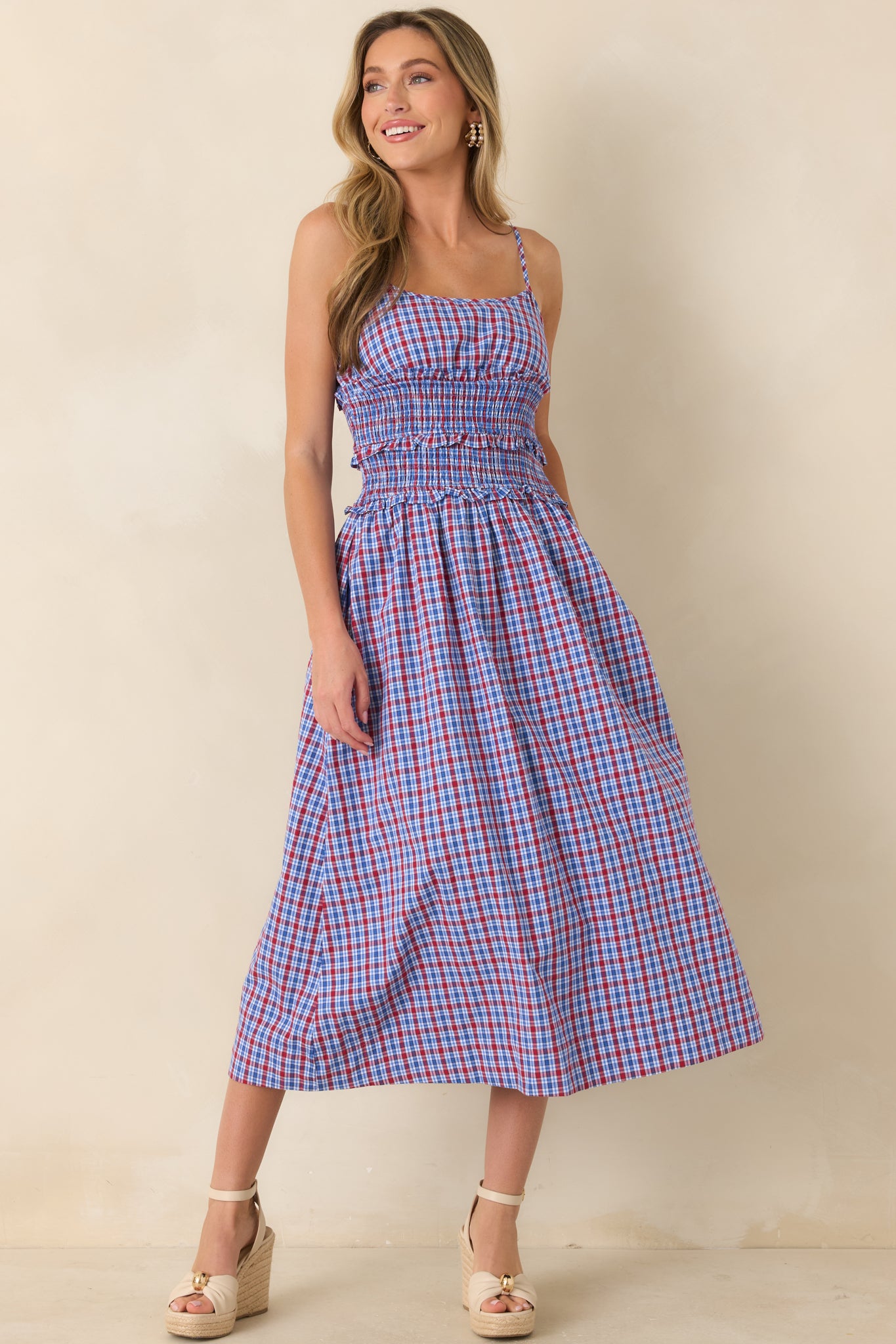 Feminine dress featuring a comfortable smocked top, soft ruffle accents, delicate straps, and a graceful gathered skirt.
