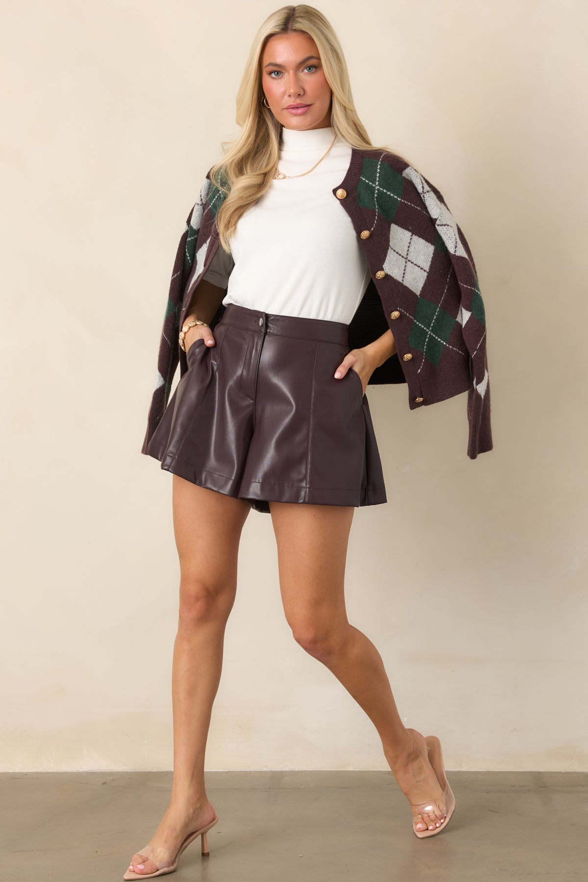 Fig purple shorts featuring a high-rise waist, front pleats, and relaxed leg opening.