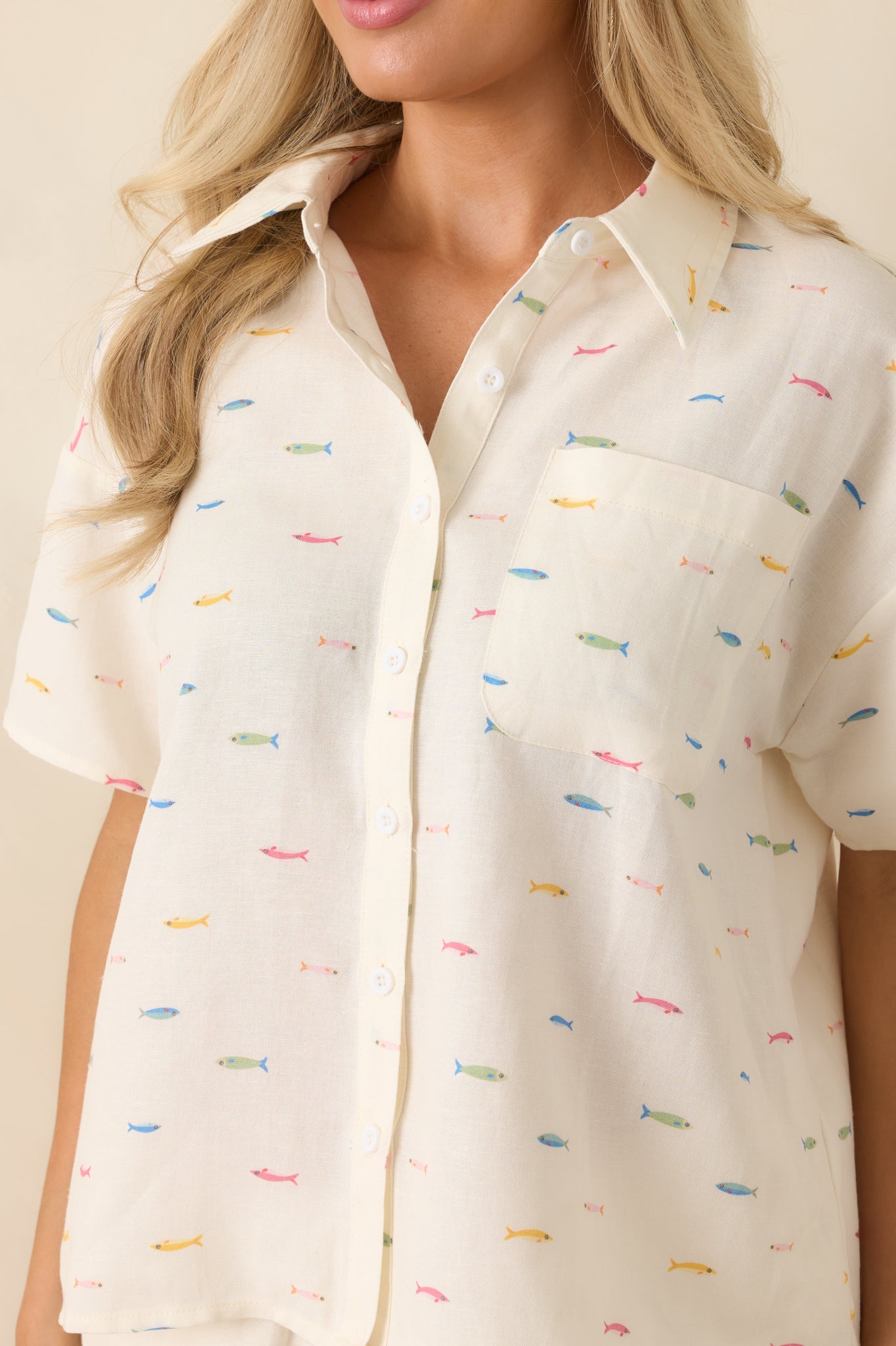 Close-up of the colorful fish print, button-front construction, and breathable cotton-linen blend texture.