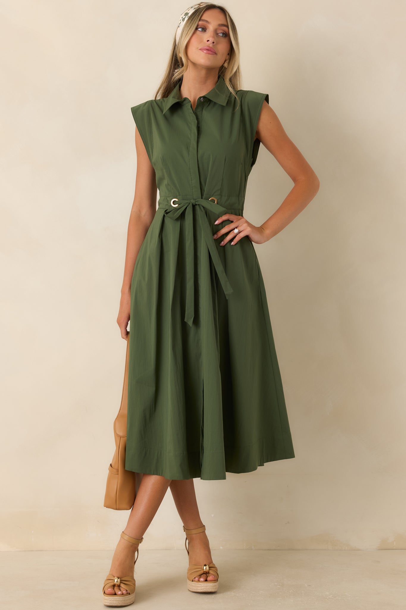 Fit-and-flare midi dress featuring crisp cotton fabric, cap sleeves, hidden pockets, and an elegant belted waist.