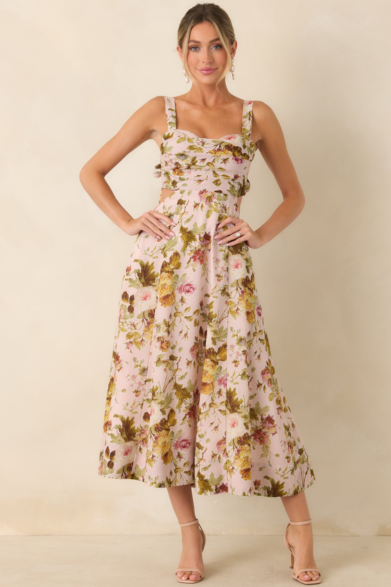 Fit-and-flare floral dress designed with adjustable tie straps, a defined waist, and an airy A-line skirt.