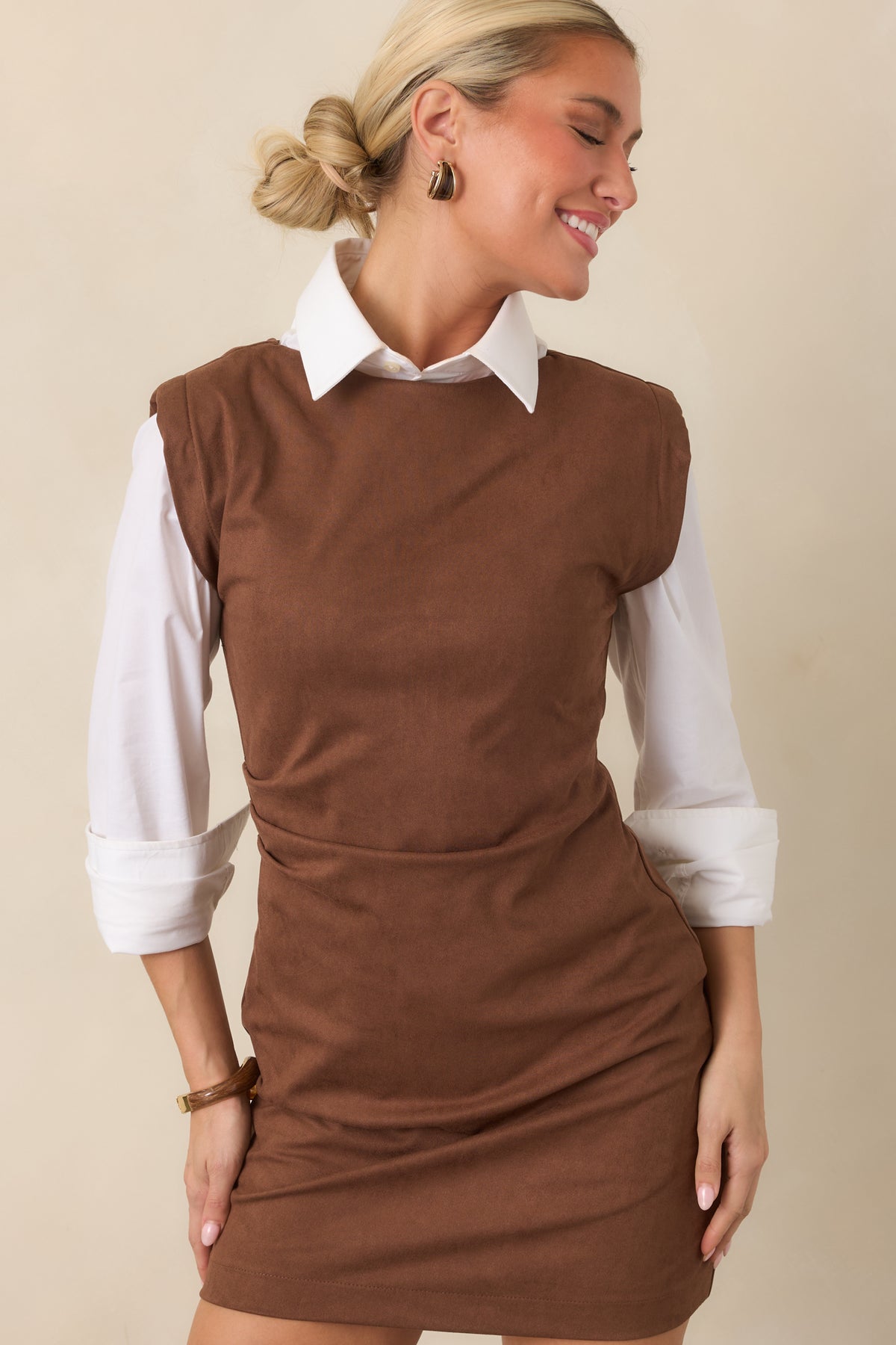 Fitted brown dress showcasing the smooth faux suede-like texture and flattering gathered waist.
