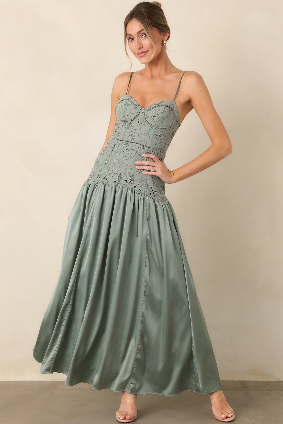 Fitted dress showcasing slim adjustable straps and an elongated dropped waist.