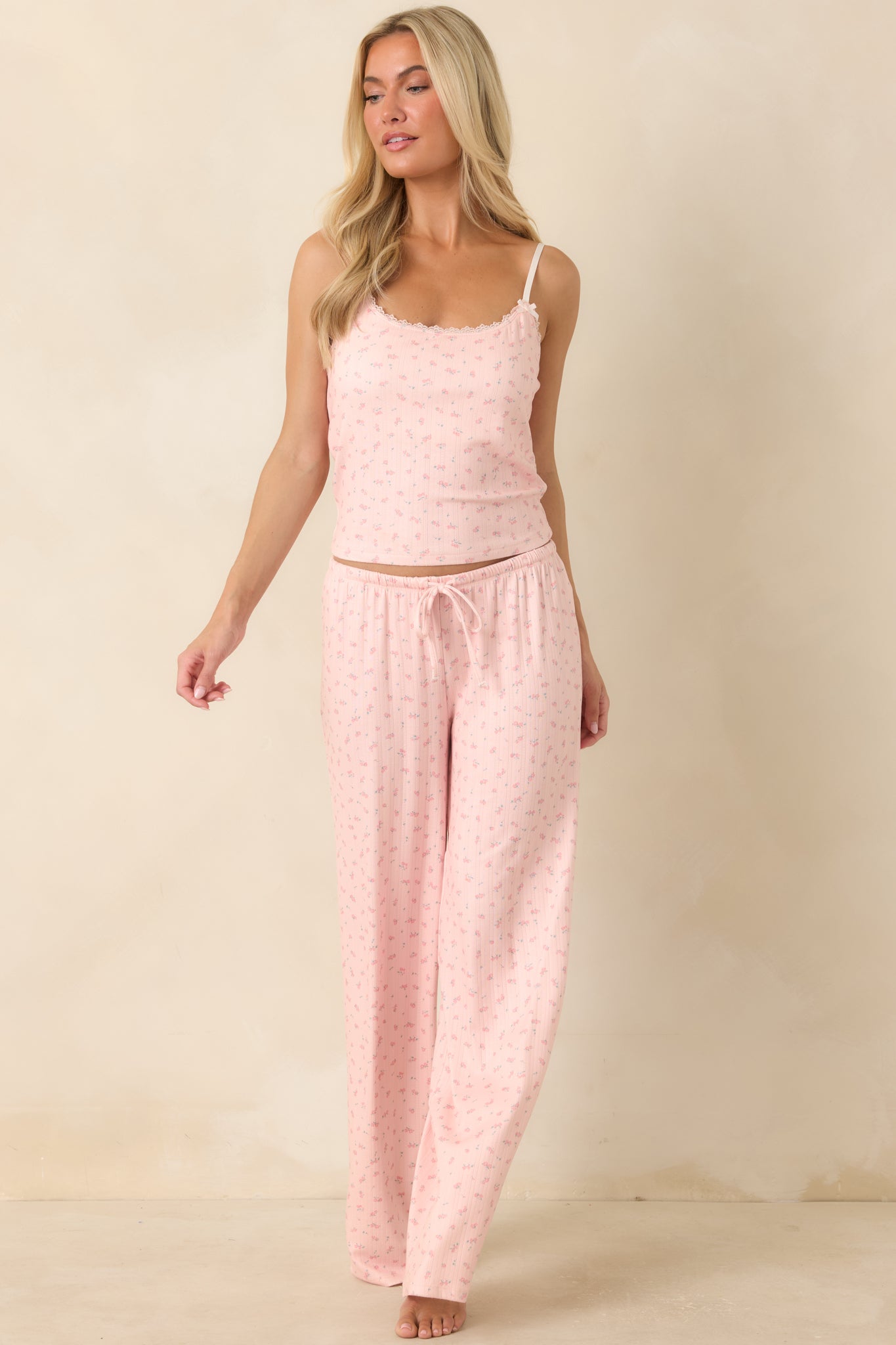 Fitted floral pajama tank designed with a built-in shelf bra, delicate satin bow accents, and soft stretch fabric.
