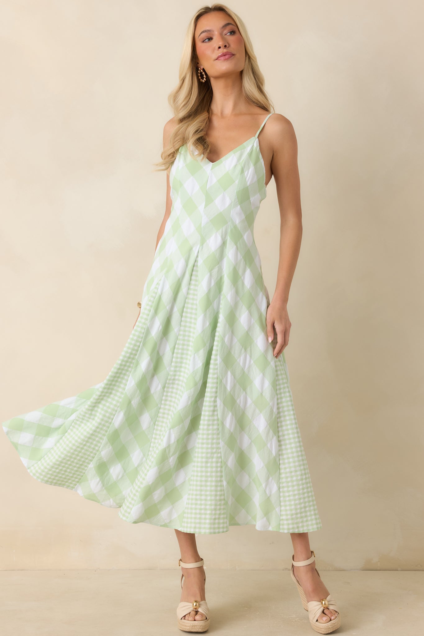 Fitted gingham midi dress featuring a feminine V-neckline and dimensional patterned panels.