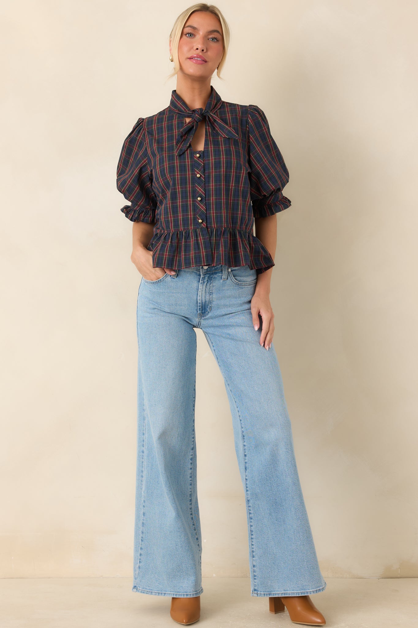Fitted peplum blouse with gold-tone buttons, softly structured sleeves, and a flattering defined waist.