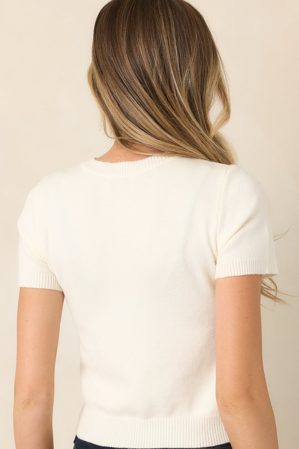 Rear of fitted rayon-blend knit top with ribbed hem trim.
