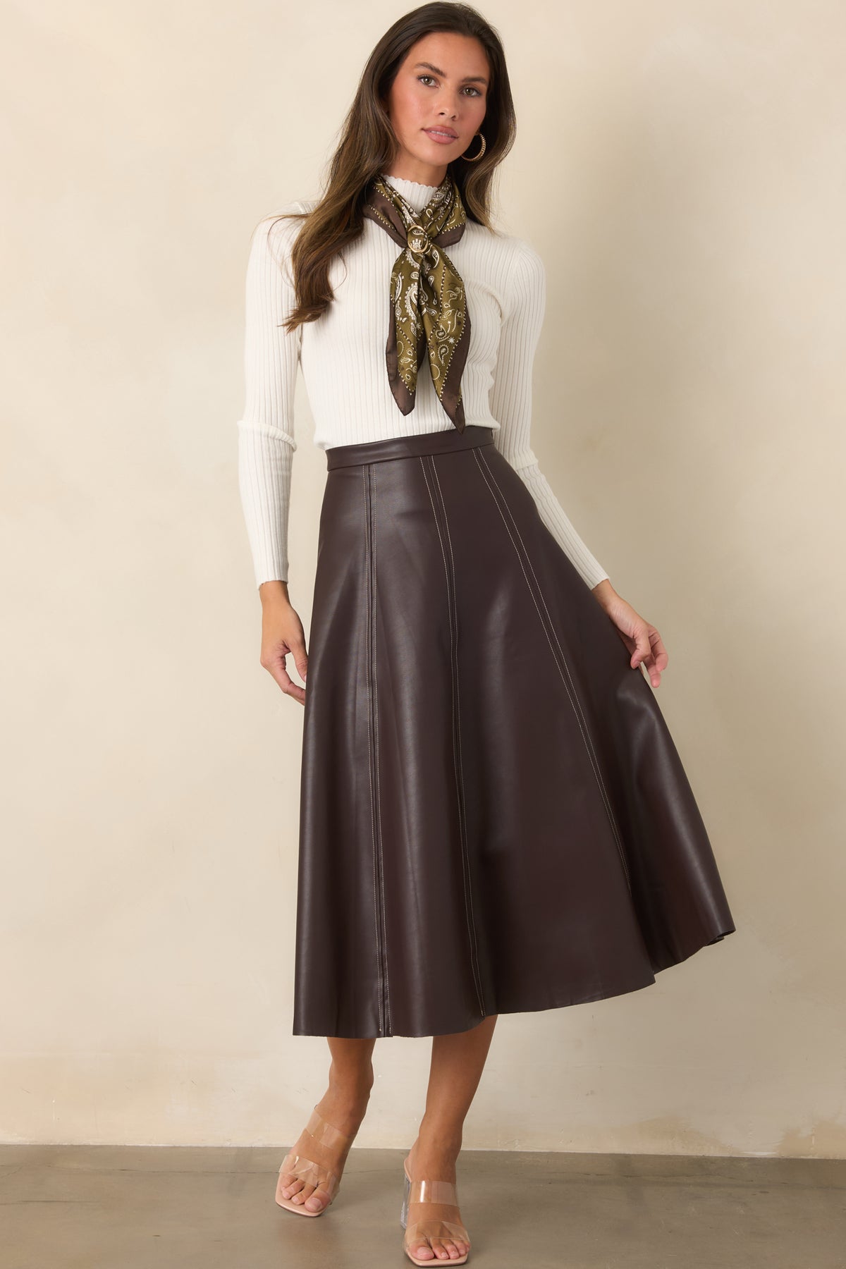 Fitted ribbed knit top features a delicate ruffled mock neckline and matching ruffle-trimmed long sleeves.