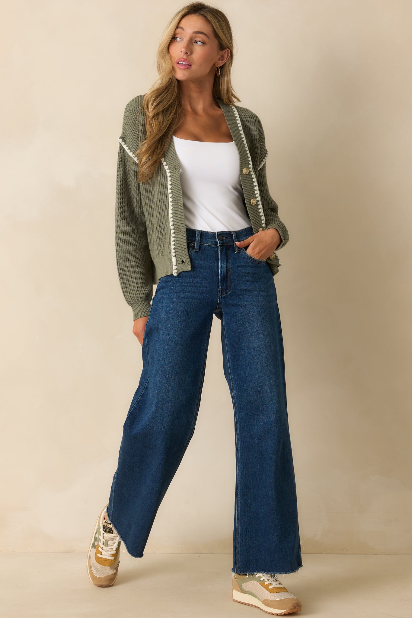 Fitted stretchy tank bodysuit in ivory, showing the smooth front and structured shape.