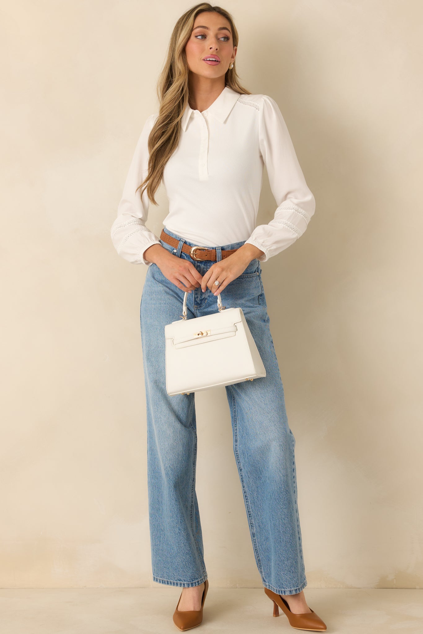 White collared knit top with half-button placket displayed in full body front view, highlighting its fitted silhouette.