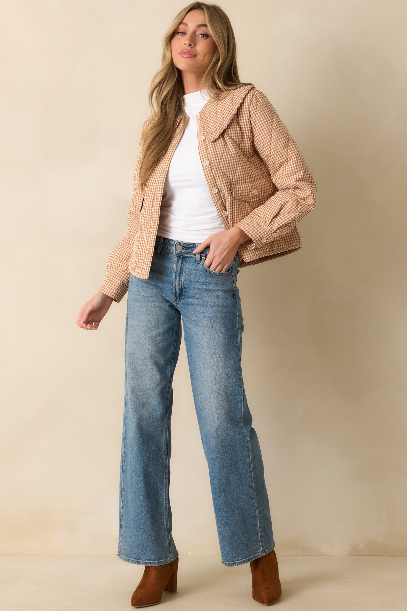 Fitted white sleeveless top highlighted by subtle side ruching and clean hemline.