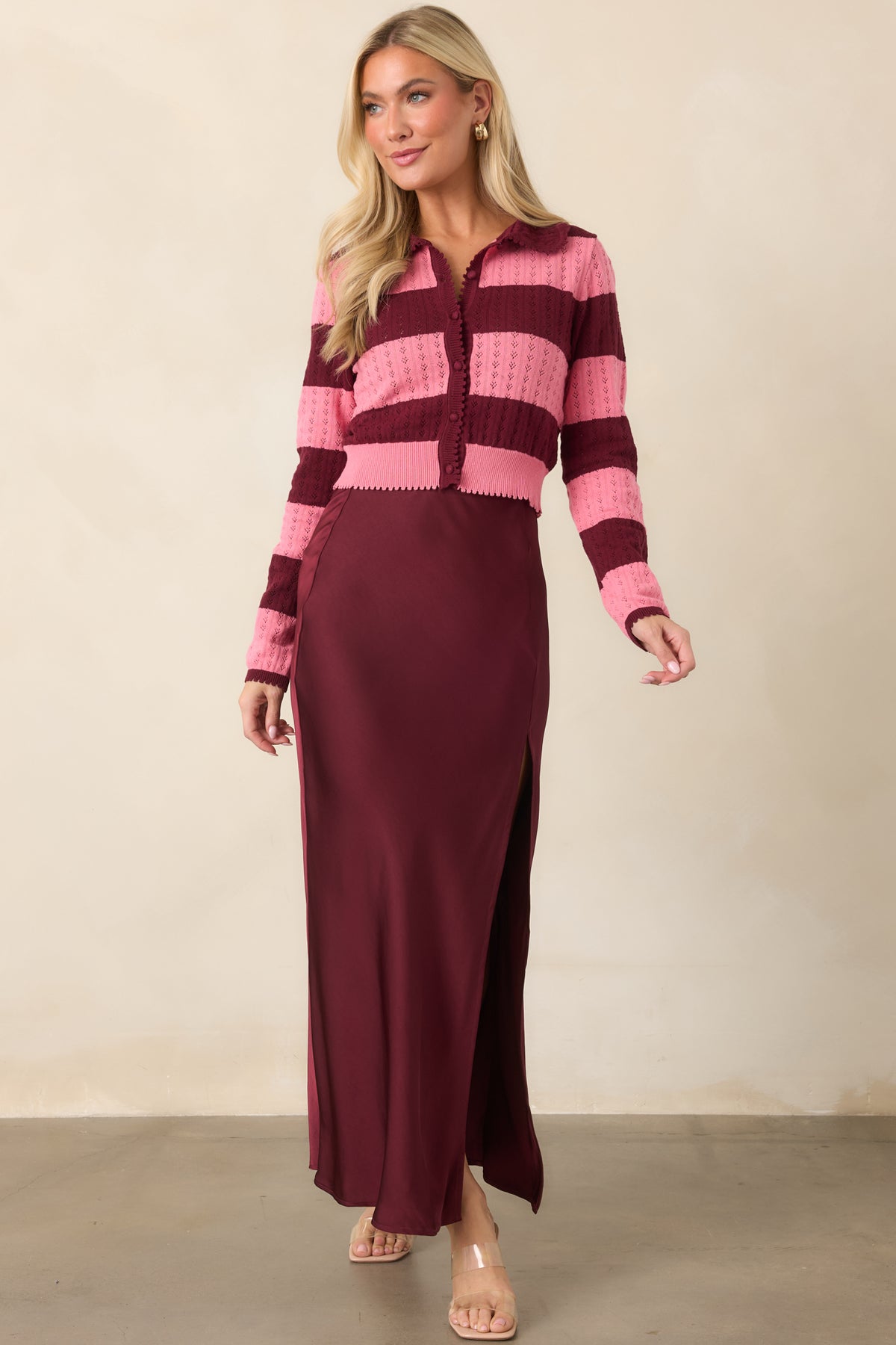 Fitted cropped cardigan combining alternating wine and pink bands with subtly scalloped edging.