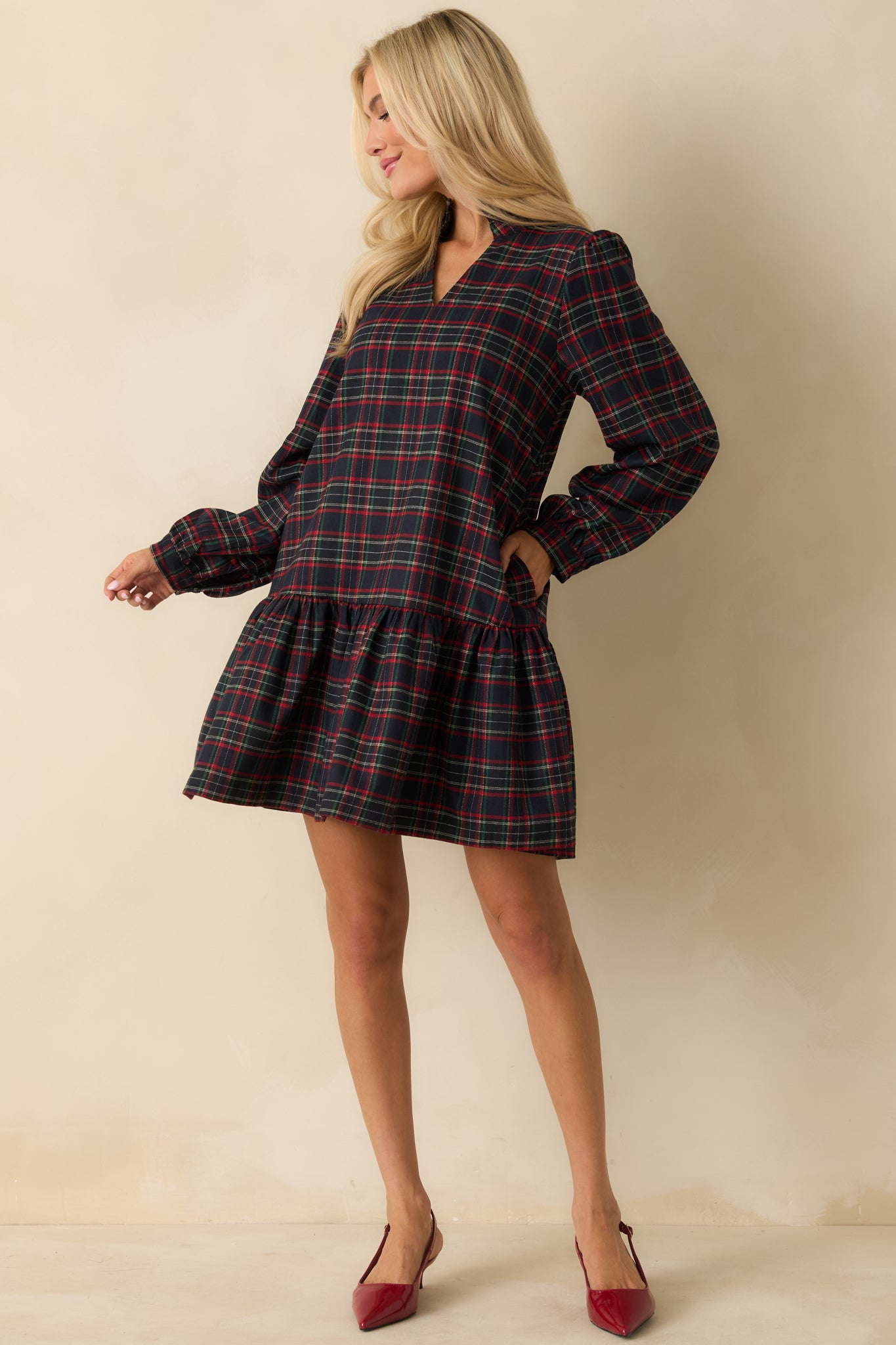 Soft flannel mini dress with plaid pattern, split neckline, standing collar, and flowing tiered ruffle hem.