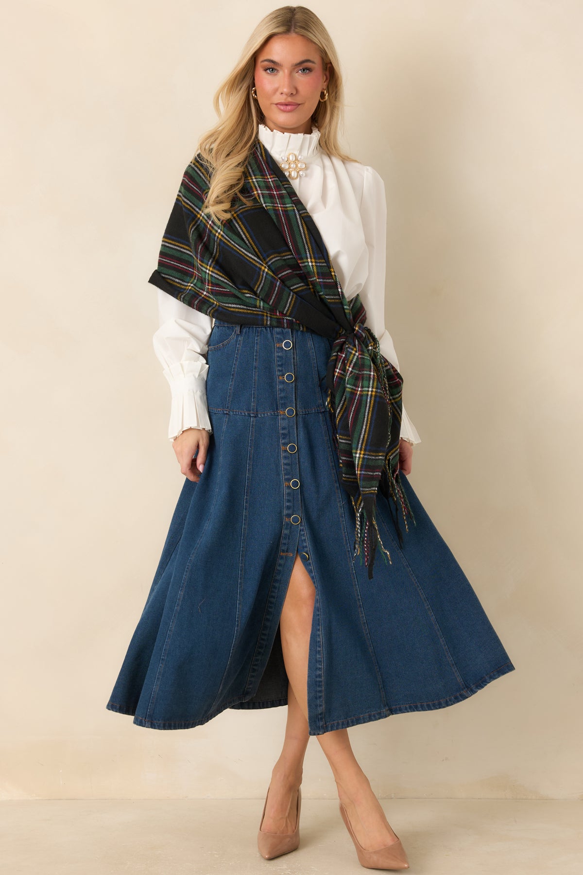 Flared denim skirt with gold-tone buttons running down the front and defined paneled seams.