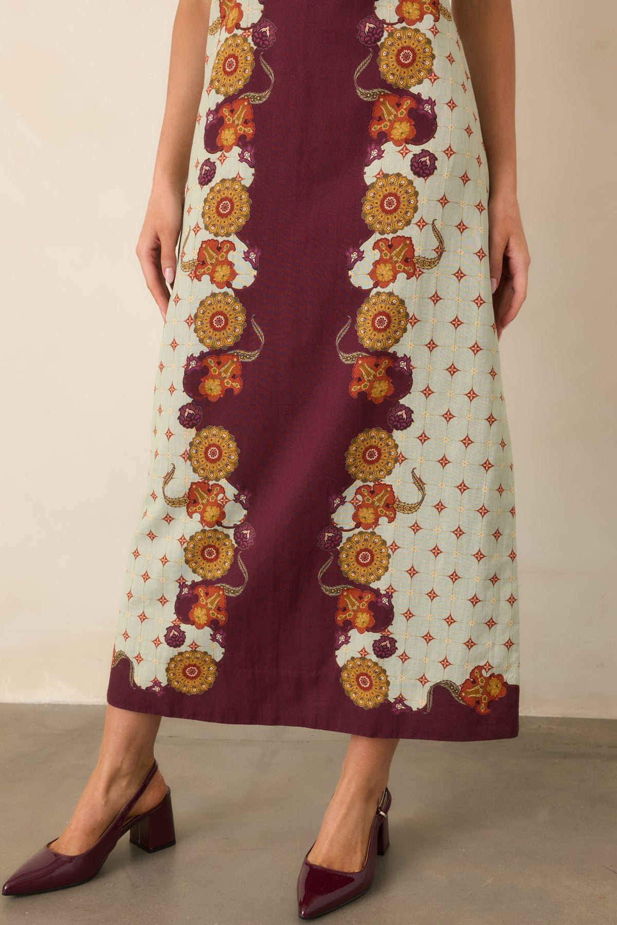 Close view of the gently flared midi skirt and colorful floral pattern near the hem.