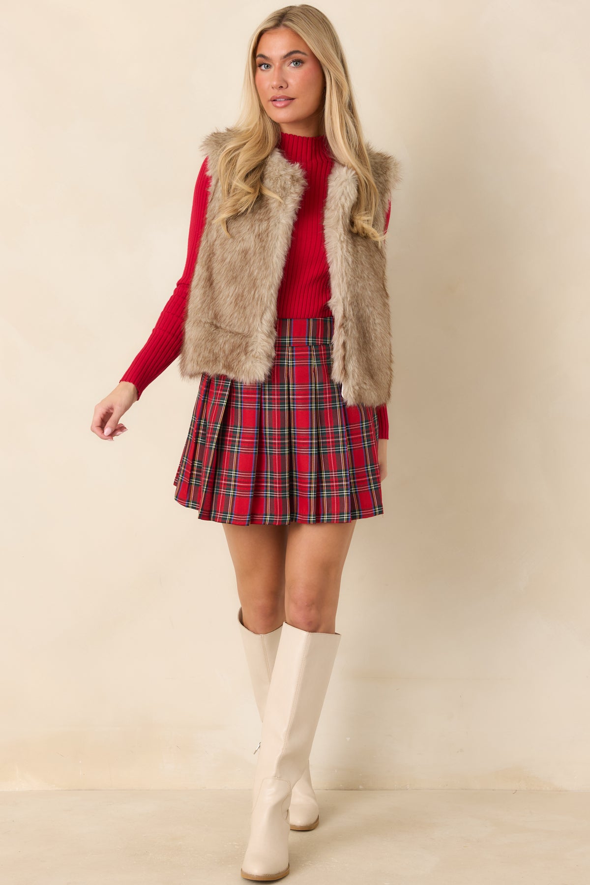 Flared pleated mini skirt featuring a structured waistband and decorative front button details.