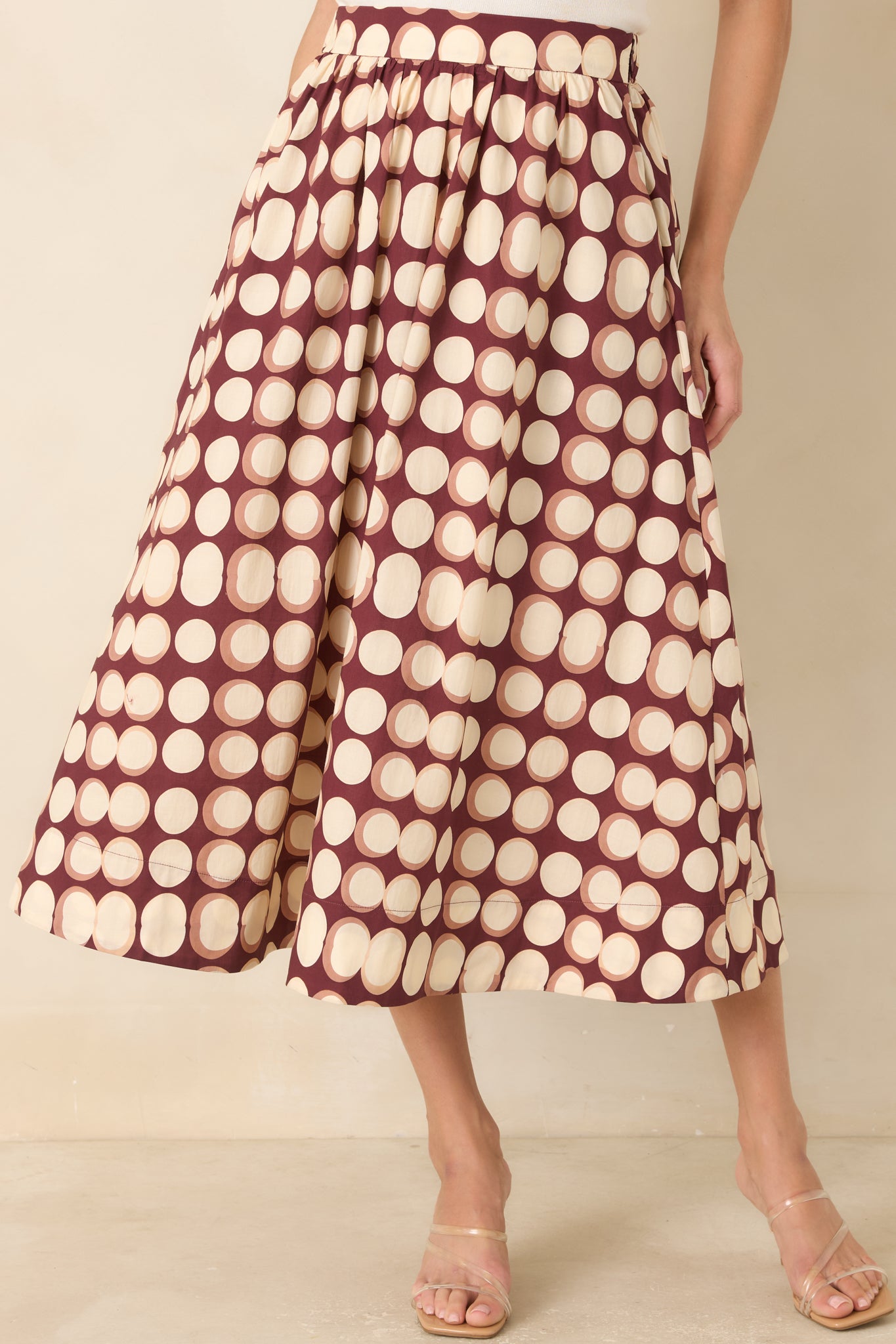 Close view of the skirt highlighting the flat front waistband, soft gathered fabric, and clean cotton construction.