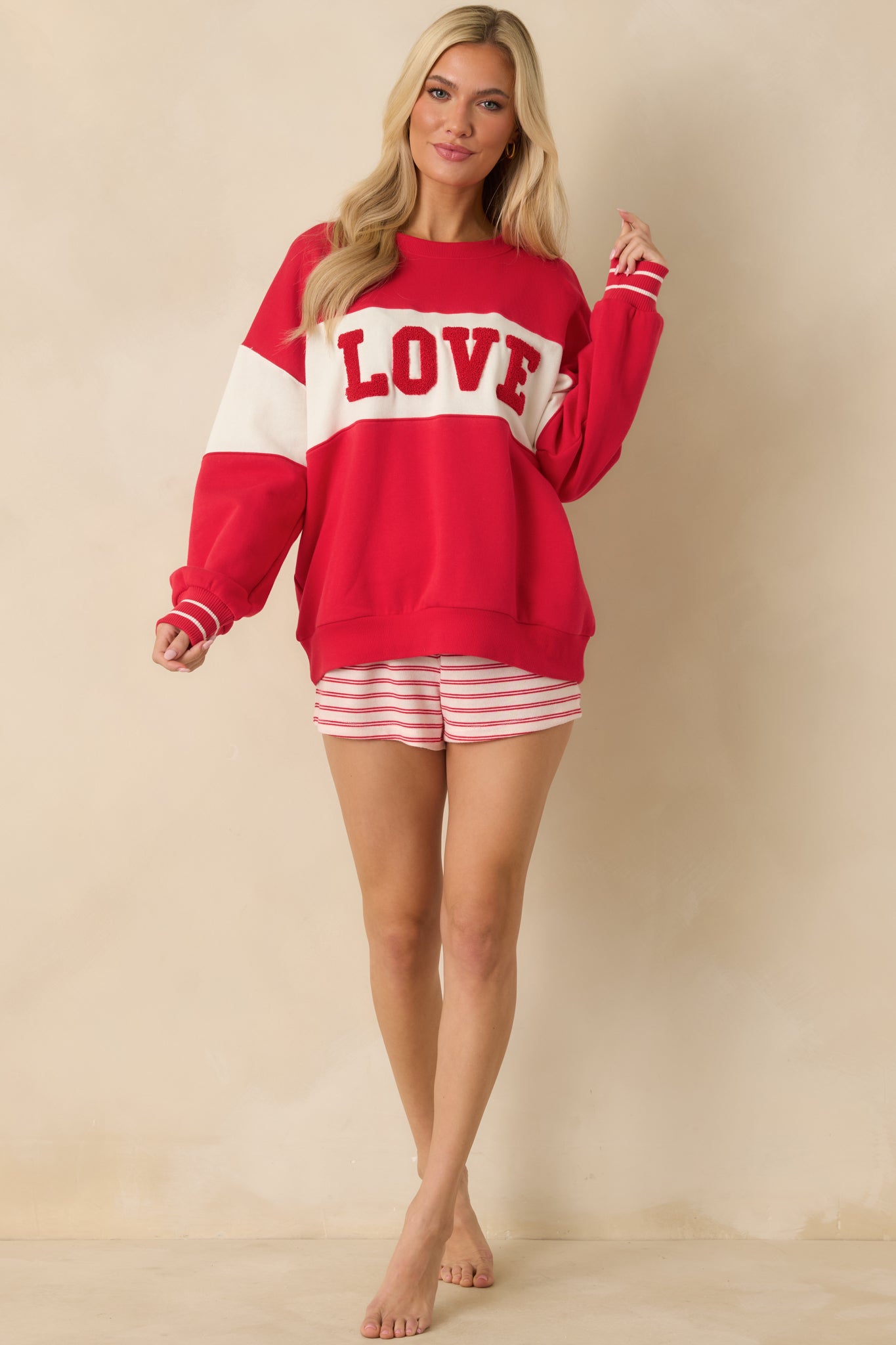 Midweight fleece sweatshirt featuring long sleeves with striped ribbed cuffs