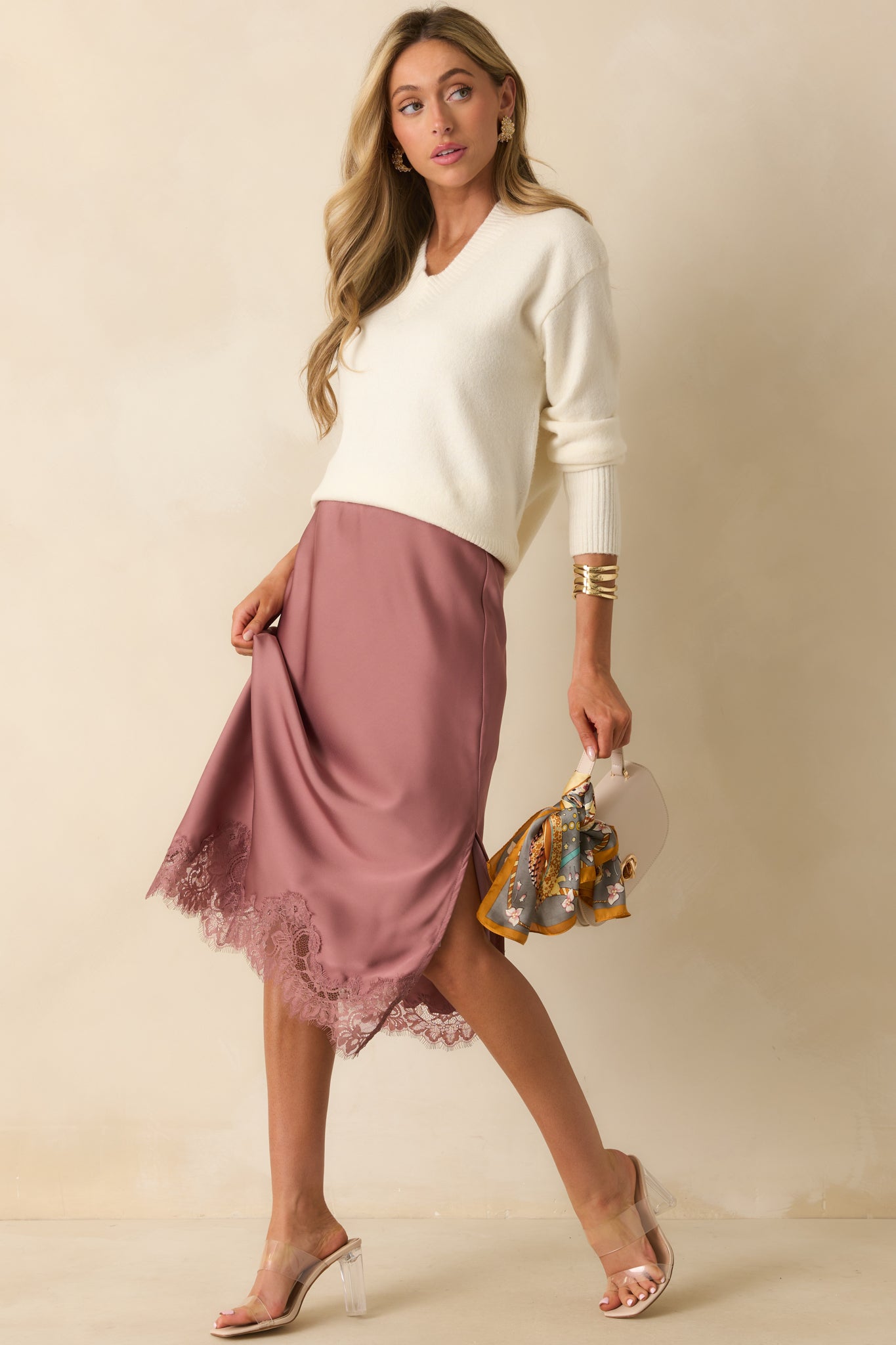 Floor-length rose pink skirt in sleek satin featuring a straight cut and delicate eyelash lace trim along the bottom edge.