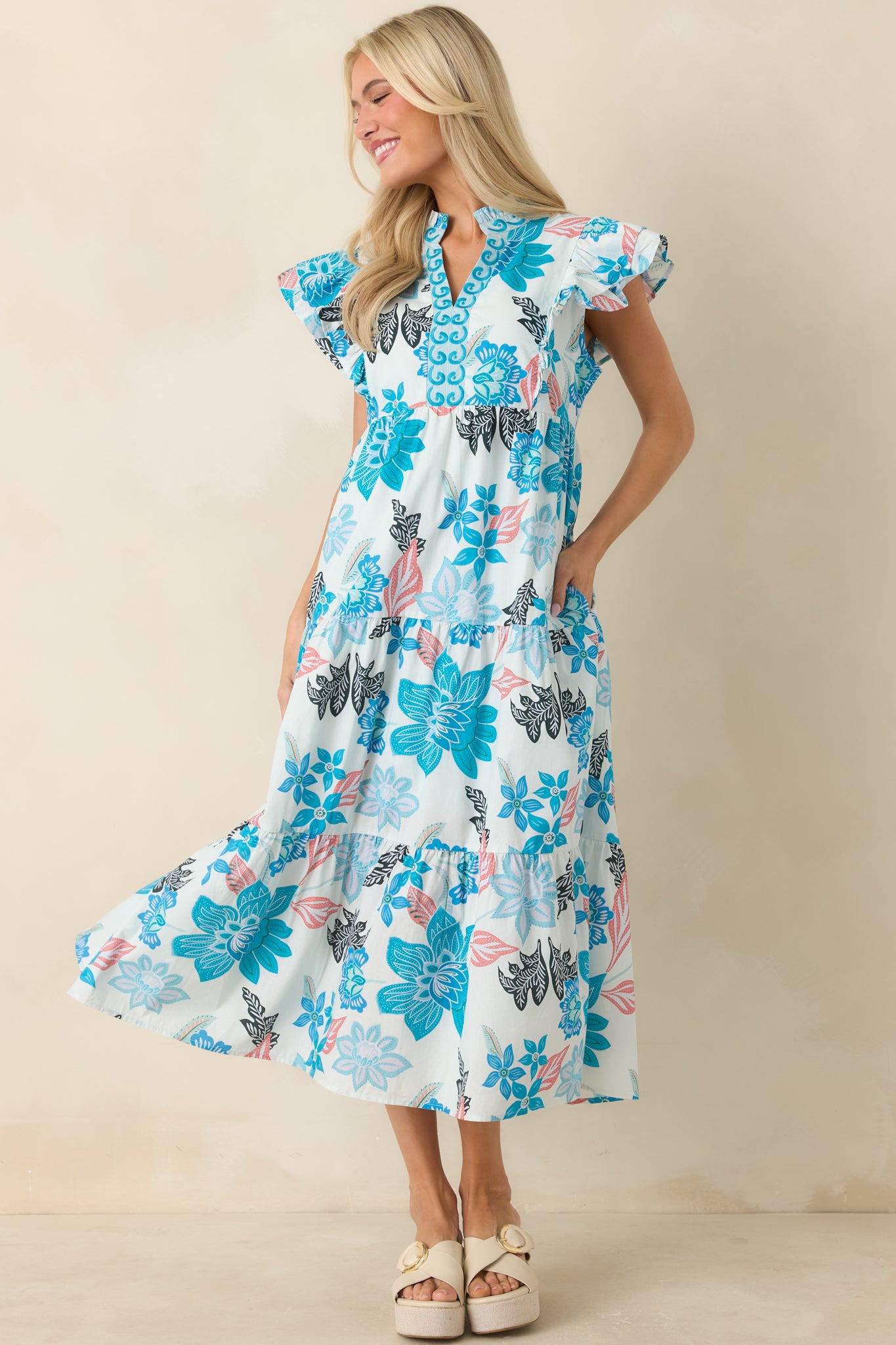 Floral blue midi dress featuring a tiered skirt, soft ruffle collar, and effortless everyday silhouette.