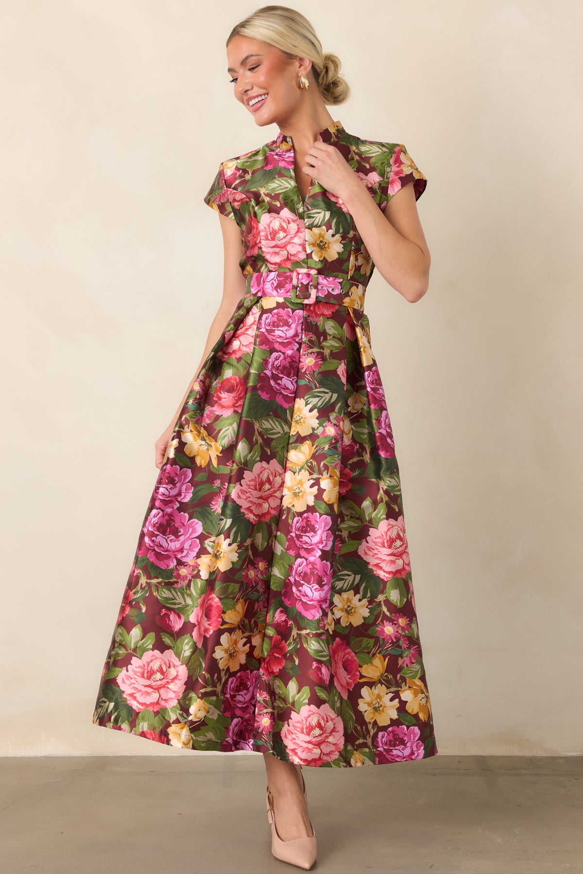 Floral burgundy dress highlighting its structured cap sleeves, matching waist belt, and softly pleated A-line silhouette.