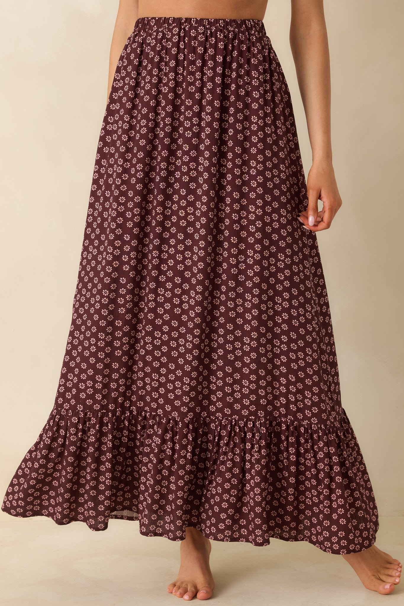 Floral burgundy maxi skirt emphasizing the ruffle trim and airy woven texture.