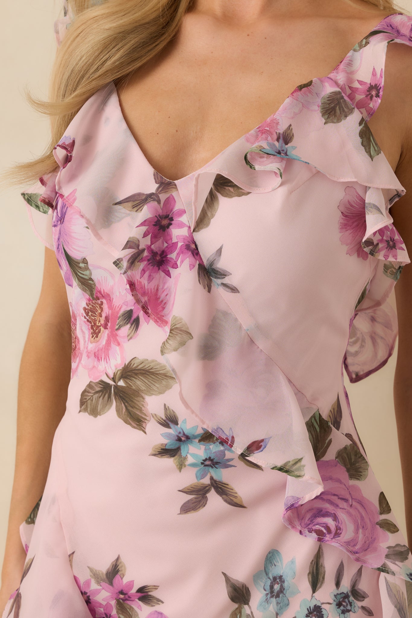 Close-up of the floral chiffon fabric showing layered ruffles and cascading hem detailing.