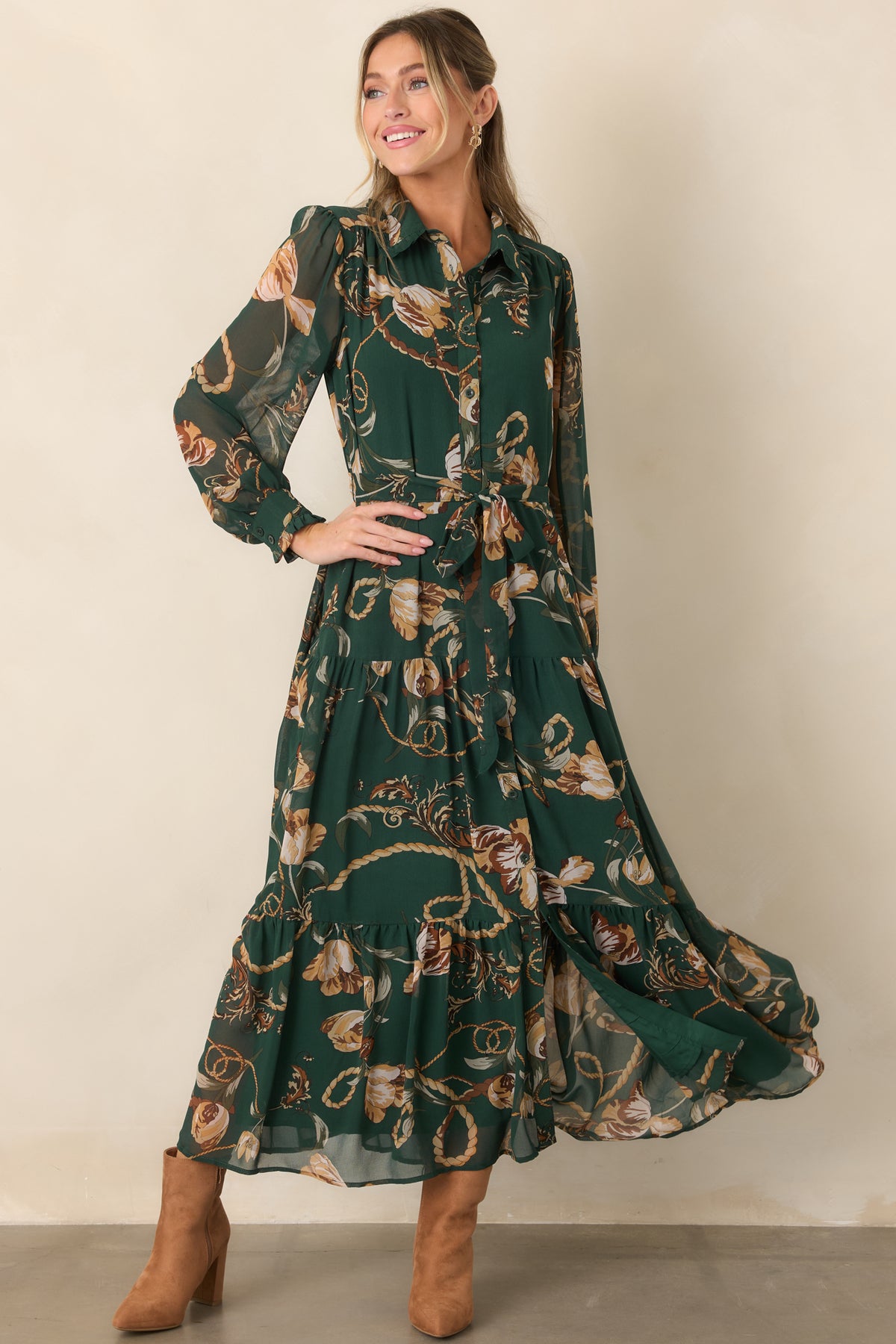 Elegant floral maxi dress with a buttoned collared bodice, softly gathered waist, translucent long sleeves, and fluid tiered construction.