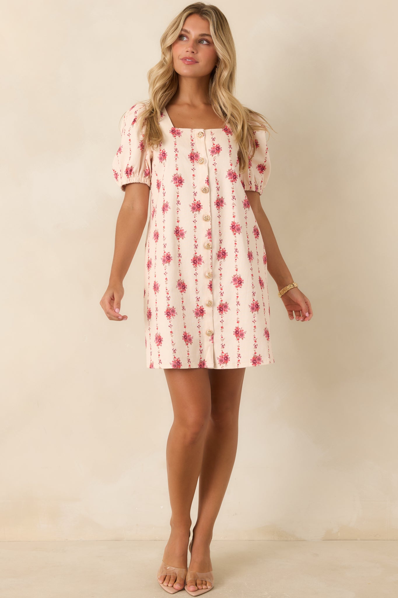 Floral cotton mini dress showcasing delicate rose vines, decorative gold buttons, a feminine silhouette, and relaxed comfort.