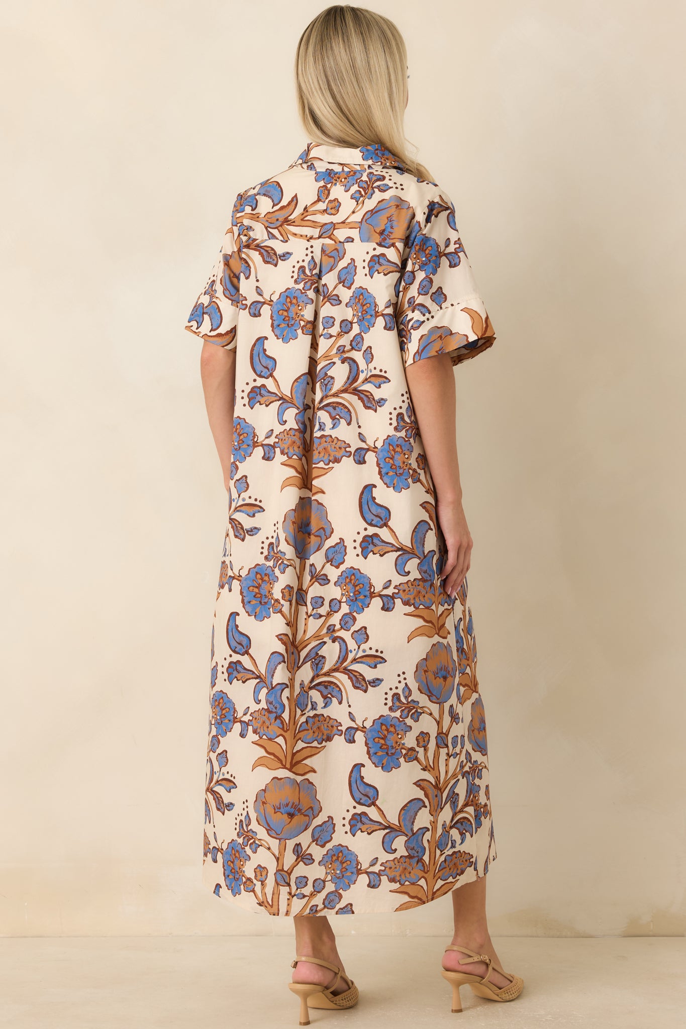 Rear view of the floral cotton shirt dress featuring a relaxed silhouette and colorful printed fabric.
