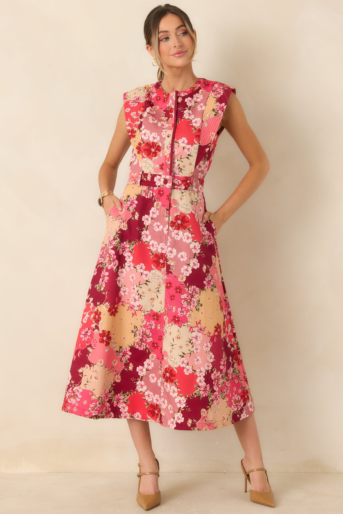 Colorful floral denim dress featuring a structured sleeveless bodice, front buttons, and a defined waistband.