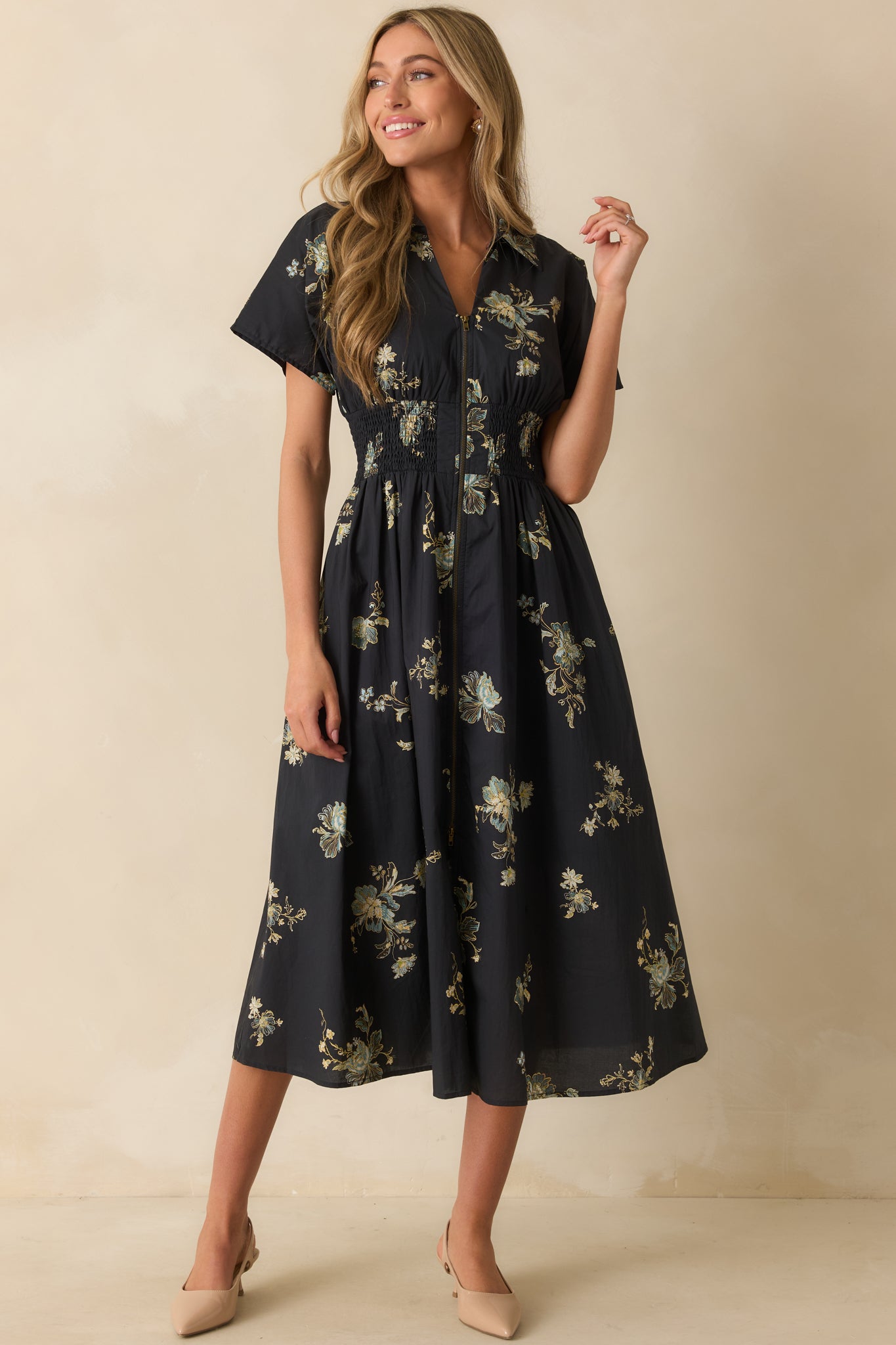 A slightly angled front view emphasizing the collar, floral pattern, and short sleeves.