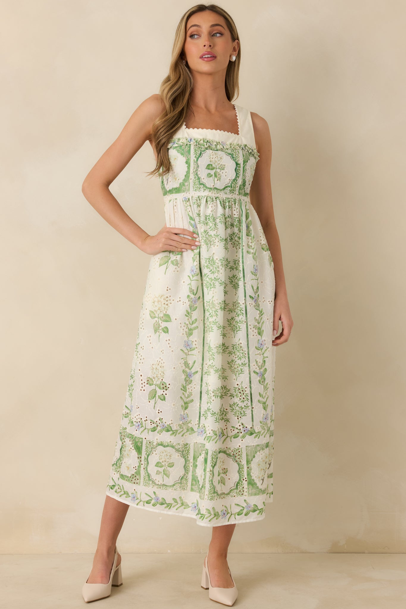 Floral maxi dress featuring a tailored upper fit with decorative detailing and a fluid skirt that creates gentle movement through the silhouette.