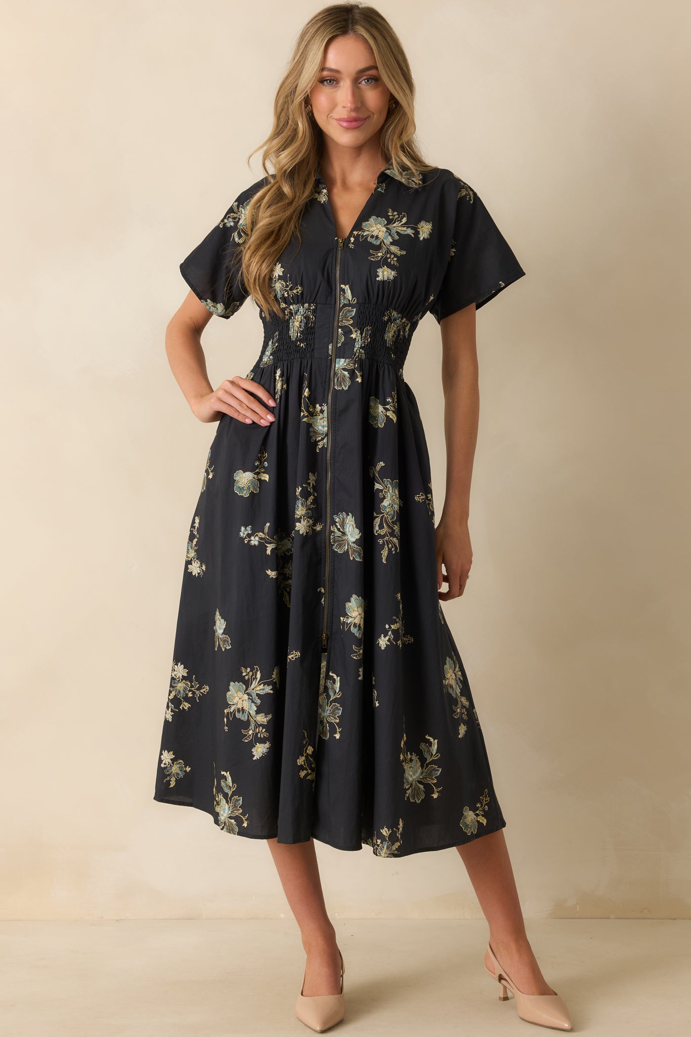A full front view showing the functional pockets and relaxed skirt silhouette of the floral dress.