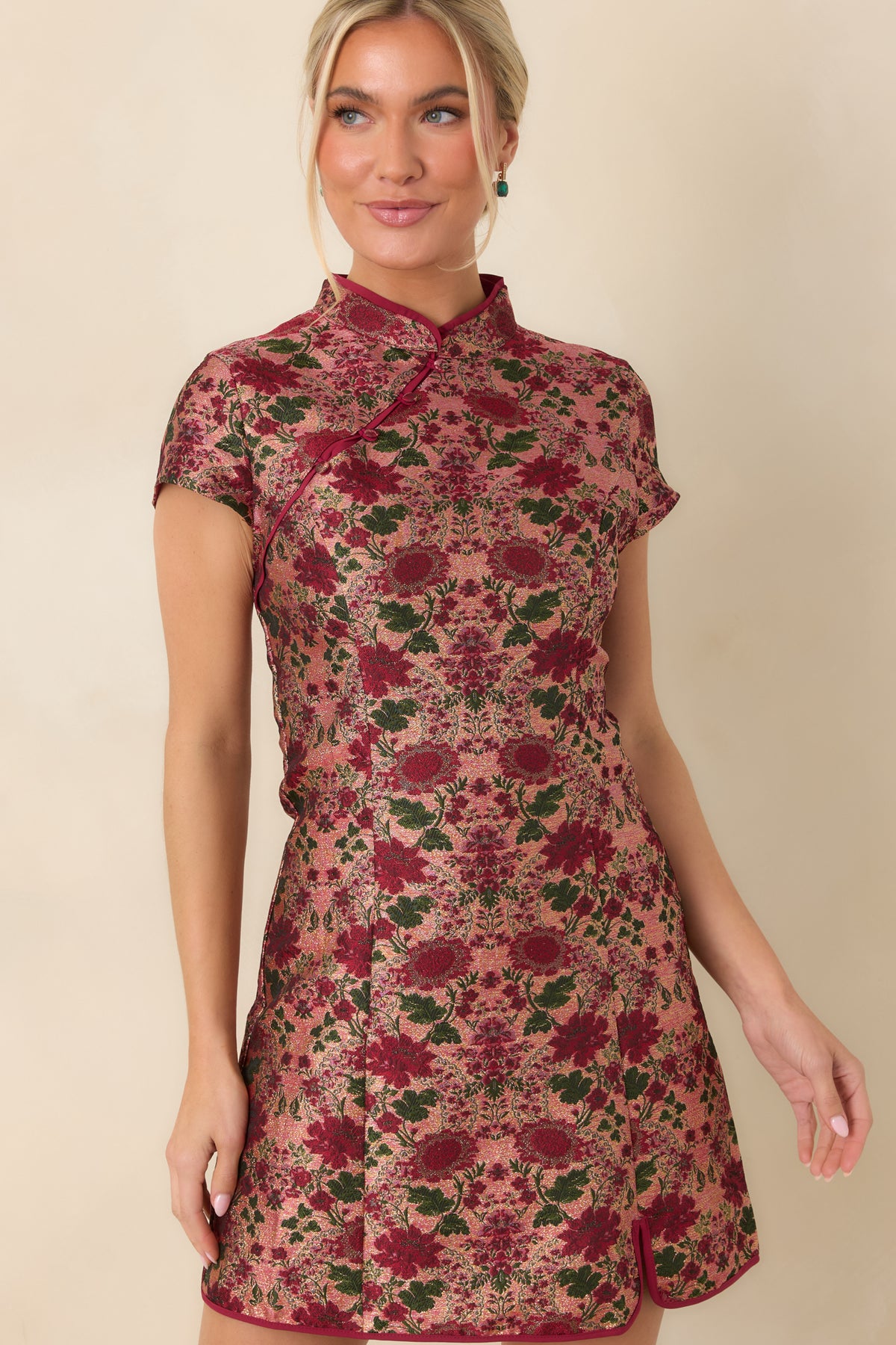 Mandarin collar and diagonal covered-button placket outlined with burgundy trim on the floral jacquard dress.