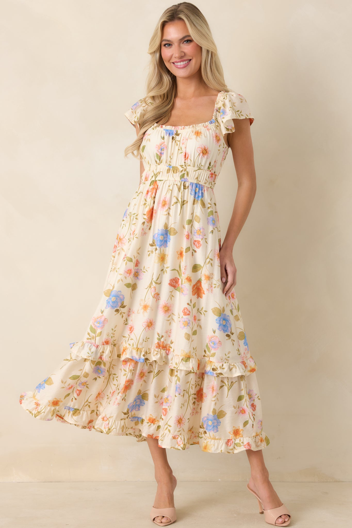 Floral midi dress featuring elastic waist and softly tiered ruffled skirt in a lightweight design.