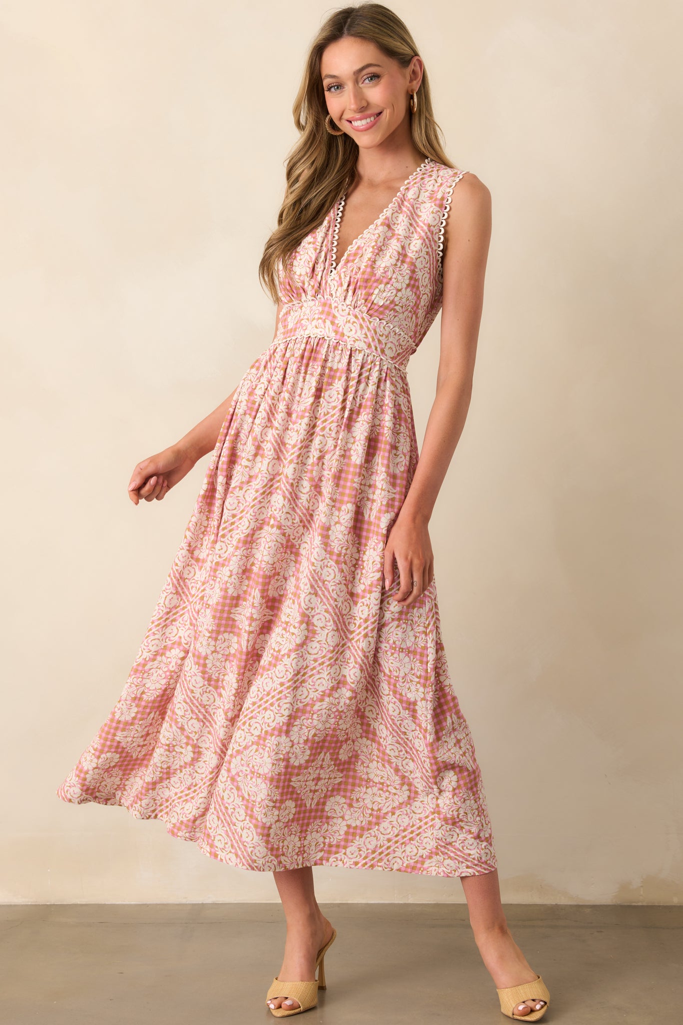 Complete look highlighting the fitted bodice, v-neckline, and flow of the dress’s floral and gingham fabric.