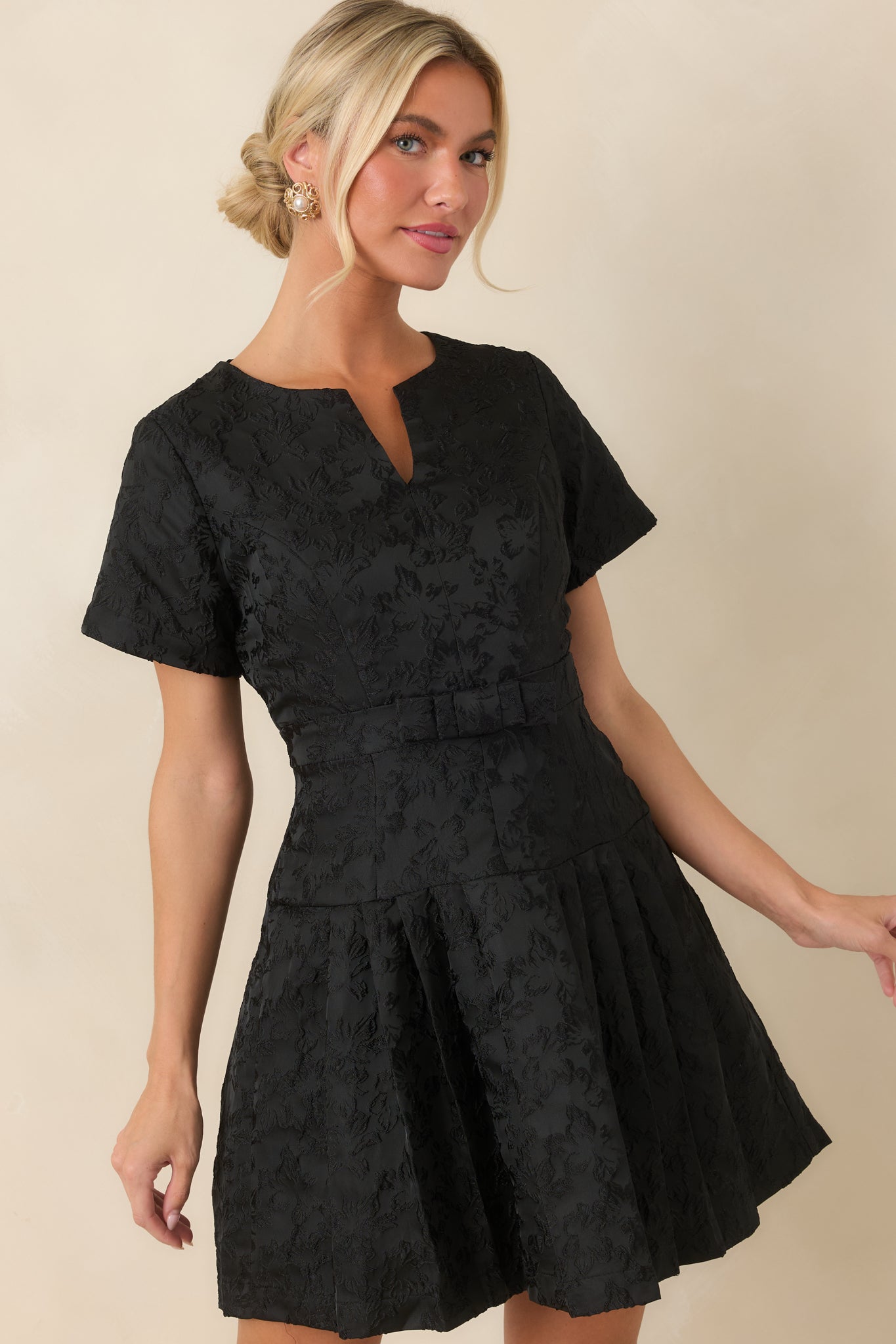 Tonal floral jacquard creates a dimensional finish across the fitted bodice of this dress.