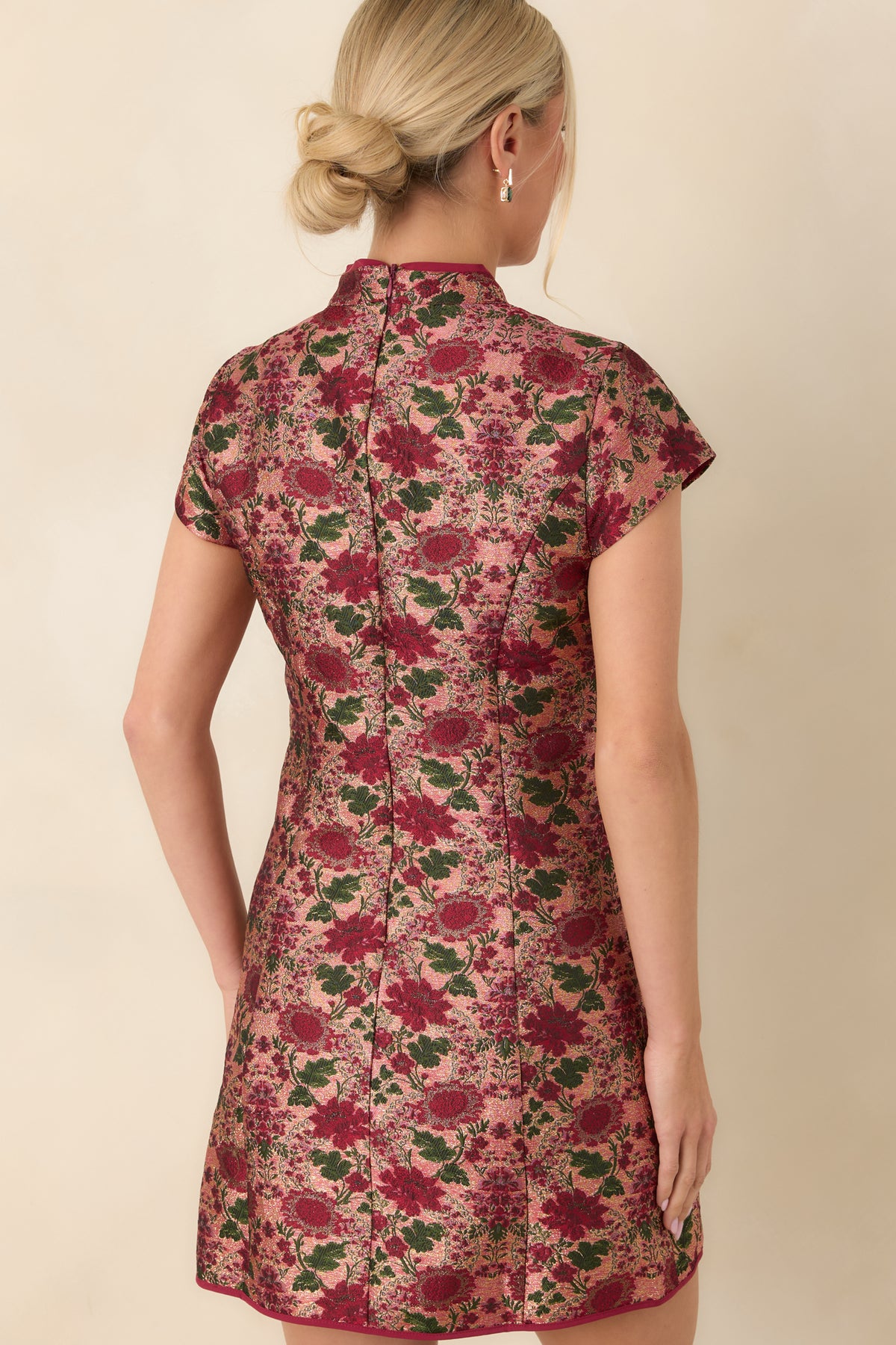 Burgundy and deep green floral jacquard mini dress with a concealed back zipper and fitted, shaped seams.