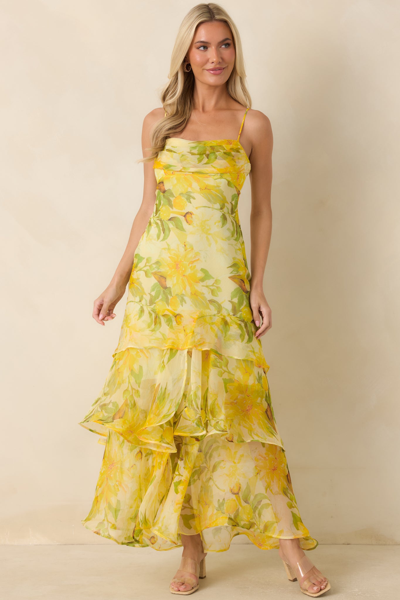 Floral print maxi dress featuring adjustable straps, a flattering drop waist, and layered skirt tiers.