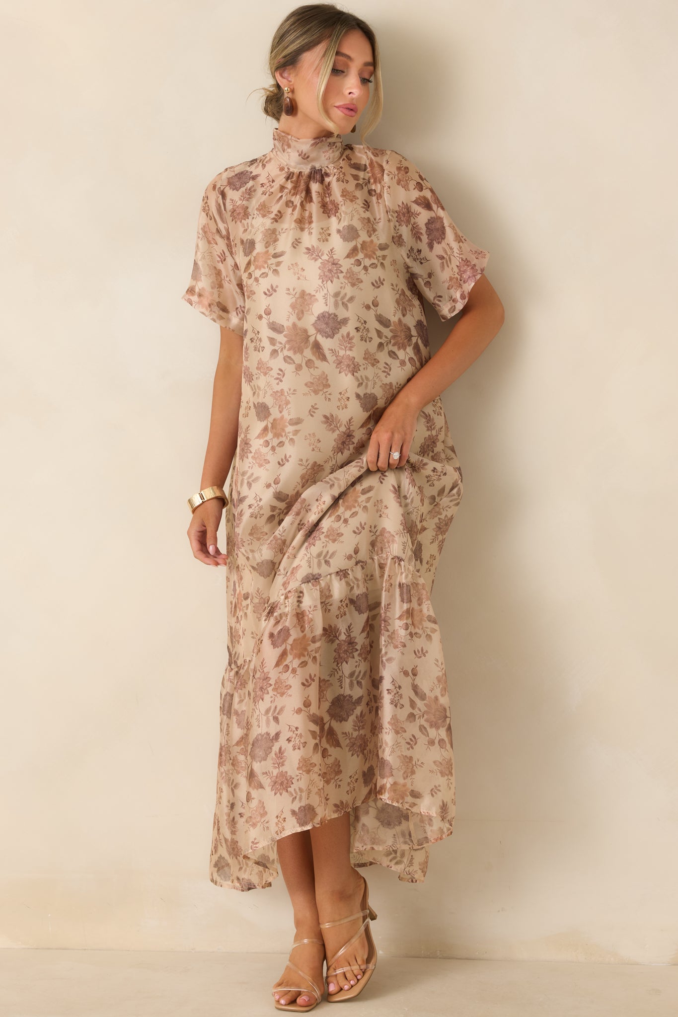 Floral maxi dress featuring a sheer patterned overlay, graceful A-line silhouette, adjustable straps, and a flowing tiered hem.
